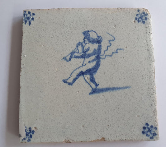 This antique Delft tile, dating from around 1660, depicts Cupid blowing a trumpet.