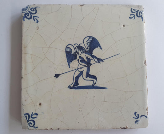 This antique Delft tile, dating from around 1640, depicts Cupid with stick.