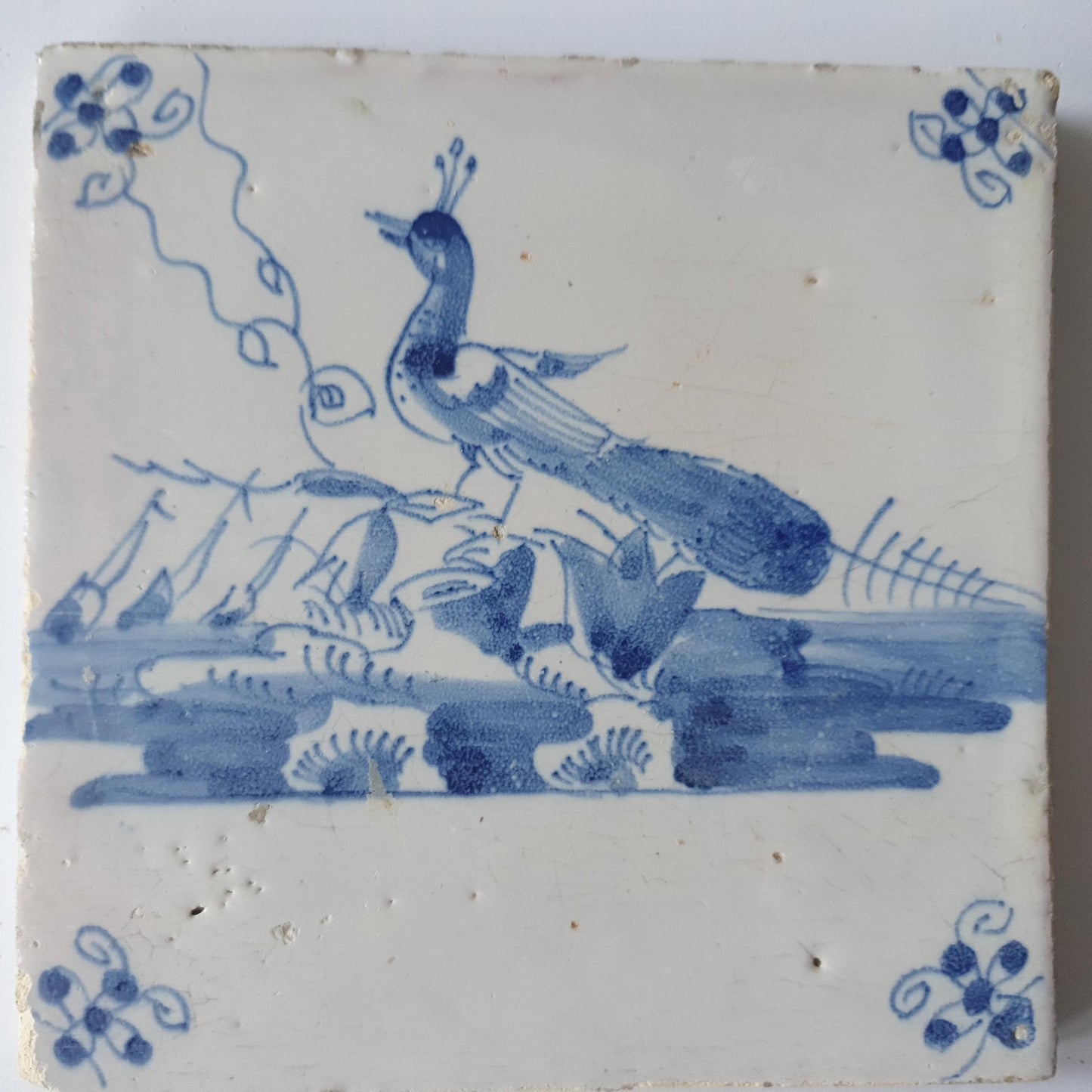 This  Delft tile depicts a peacock in blue.