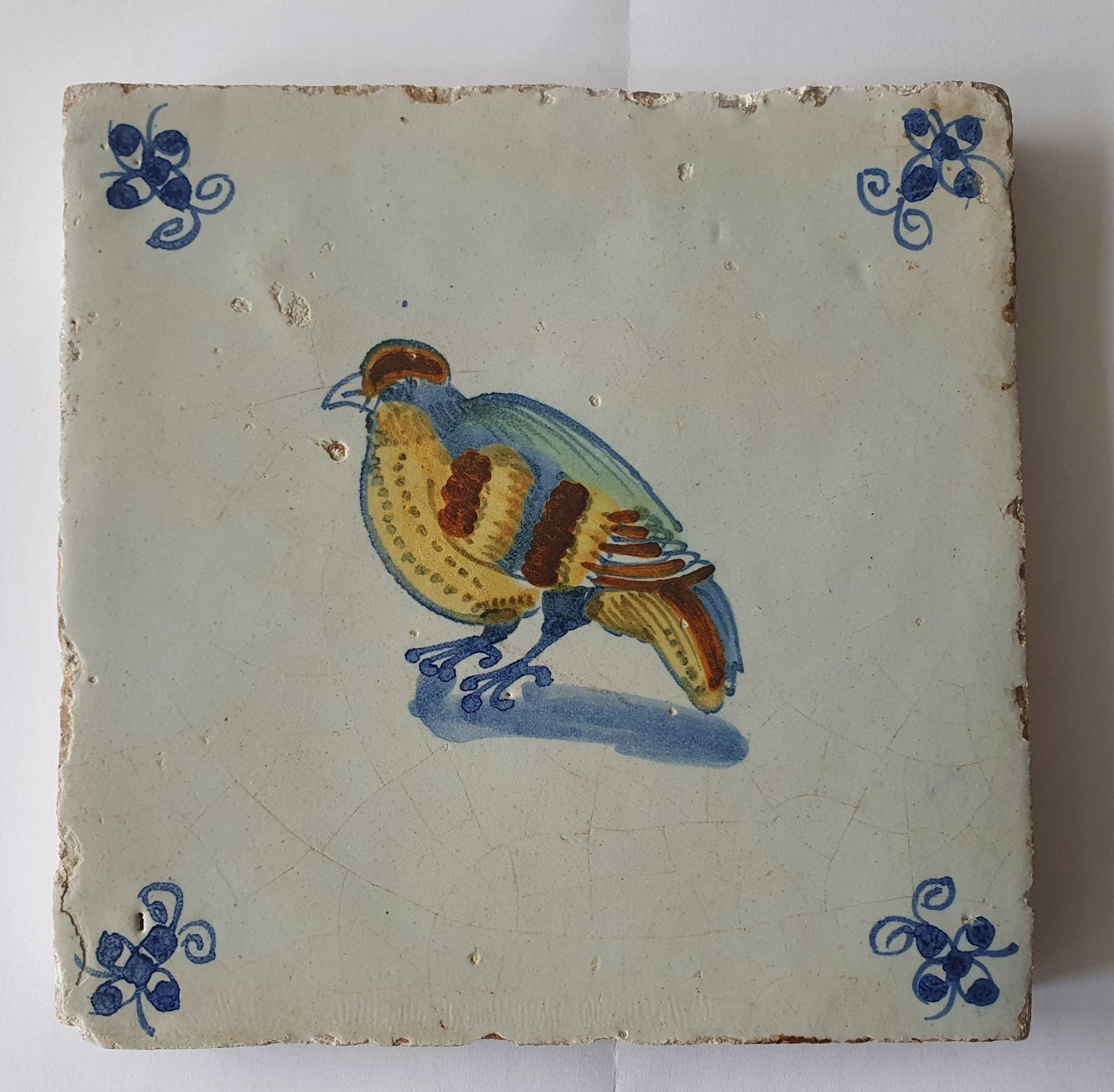 This antique Delft tile dates from around 1640 and depicts a beautifully hand-painted polychrome bird .