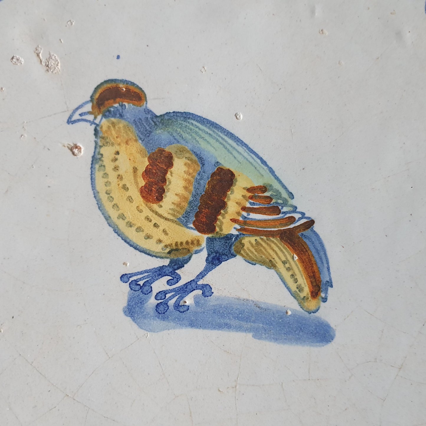 This antique Delft tile dates from around 1640 and depicts a beautifully hand-painted polychrome bird .