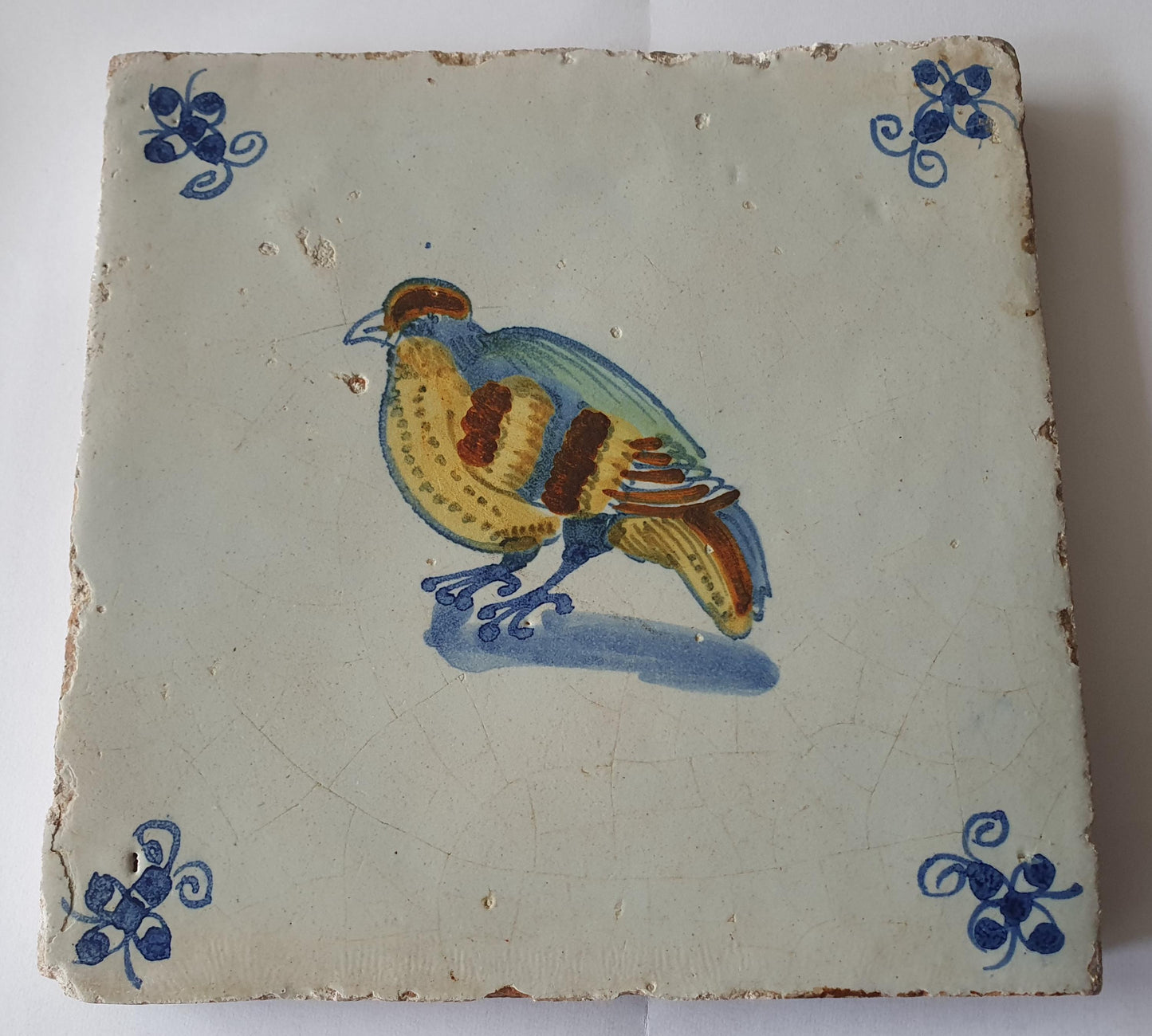 This antique Delft tile dates from around 1640 and depicts a beautifully hand-painted polychrome bird .