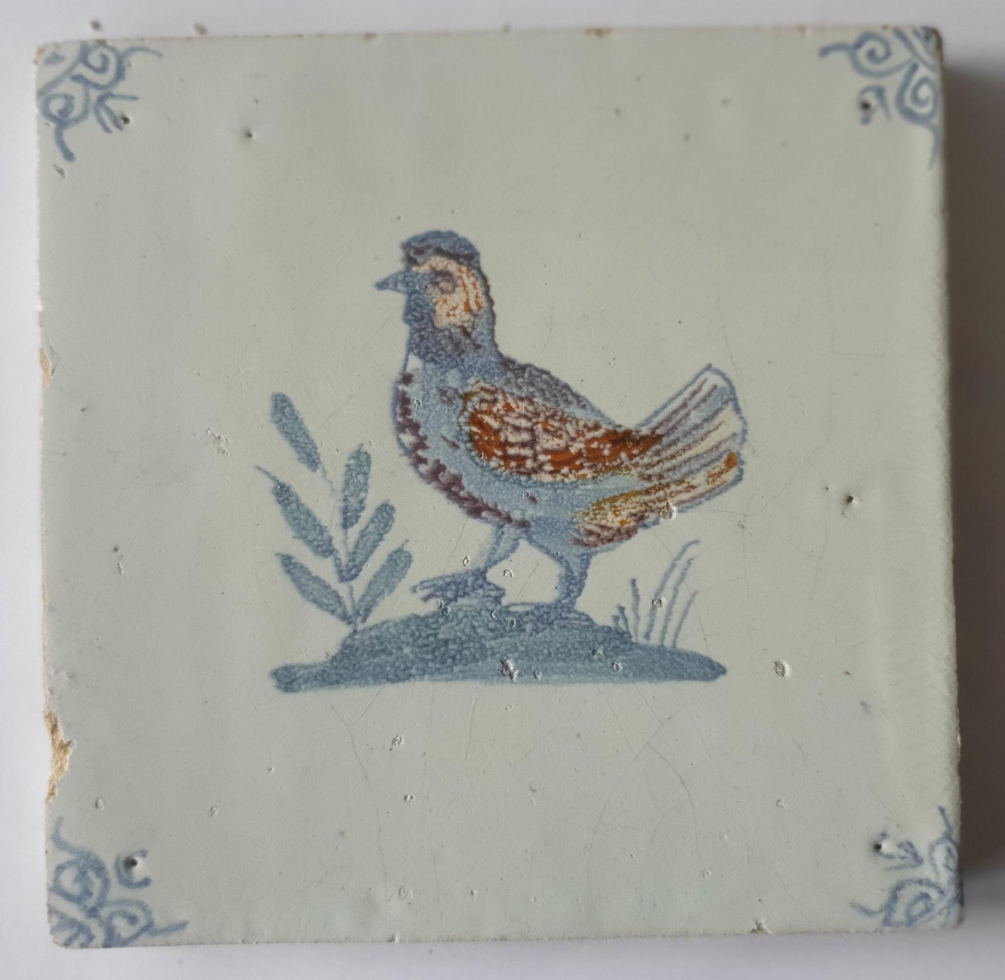 This antique Delft tile was made around 1650 and depicts a handsome rooster