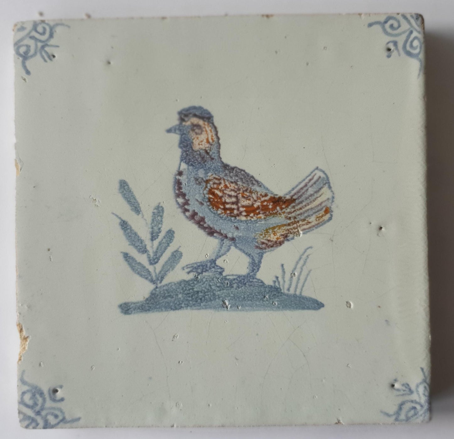 This antique Delft tile was made around 1650 and depicts a handsome rooster