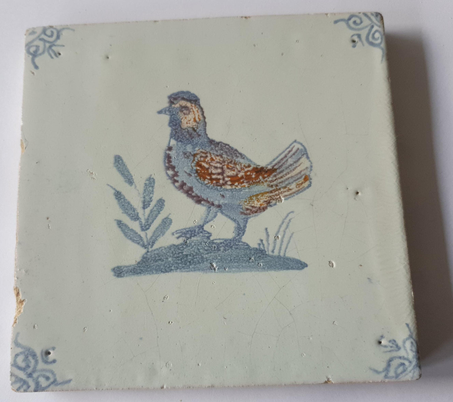 This antique Delft tile was made around 1650 and depicts a handsome rooster