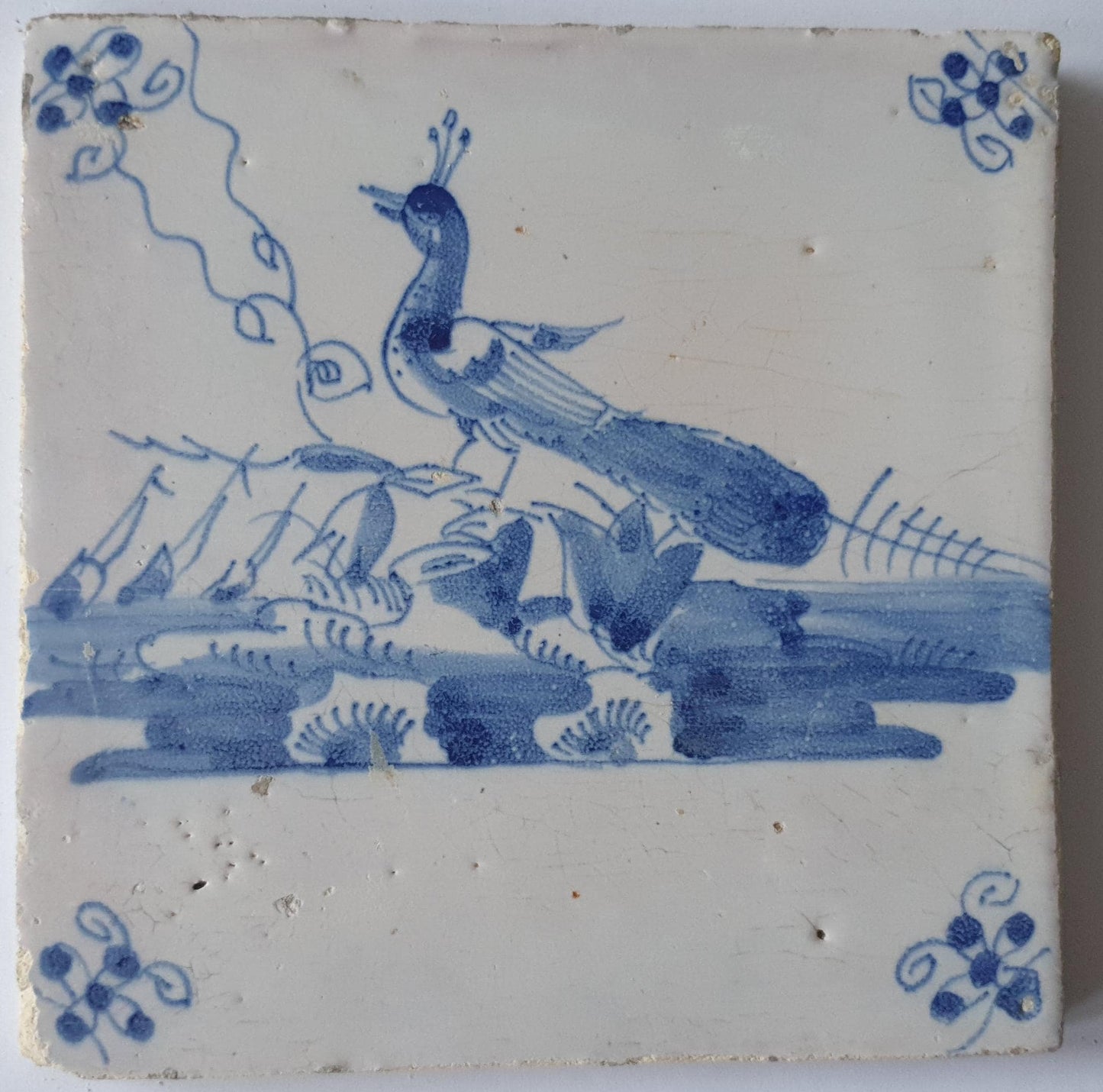 This  Delft tile depicts a peacock in blue.