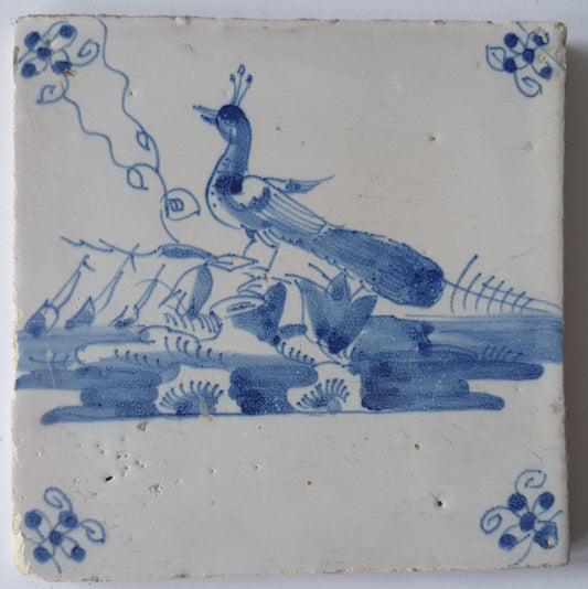 This  Delft tile depicts a peacock in blue.