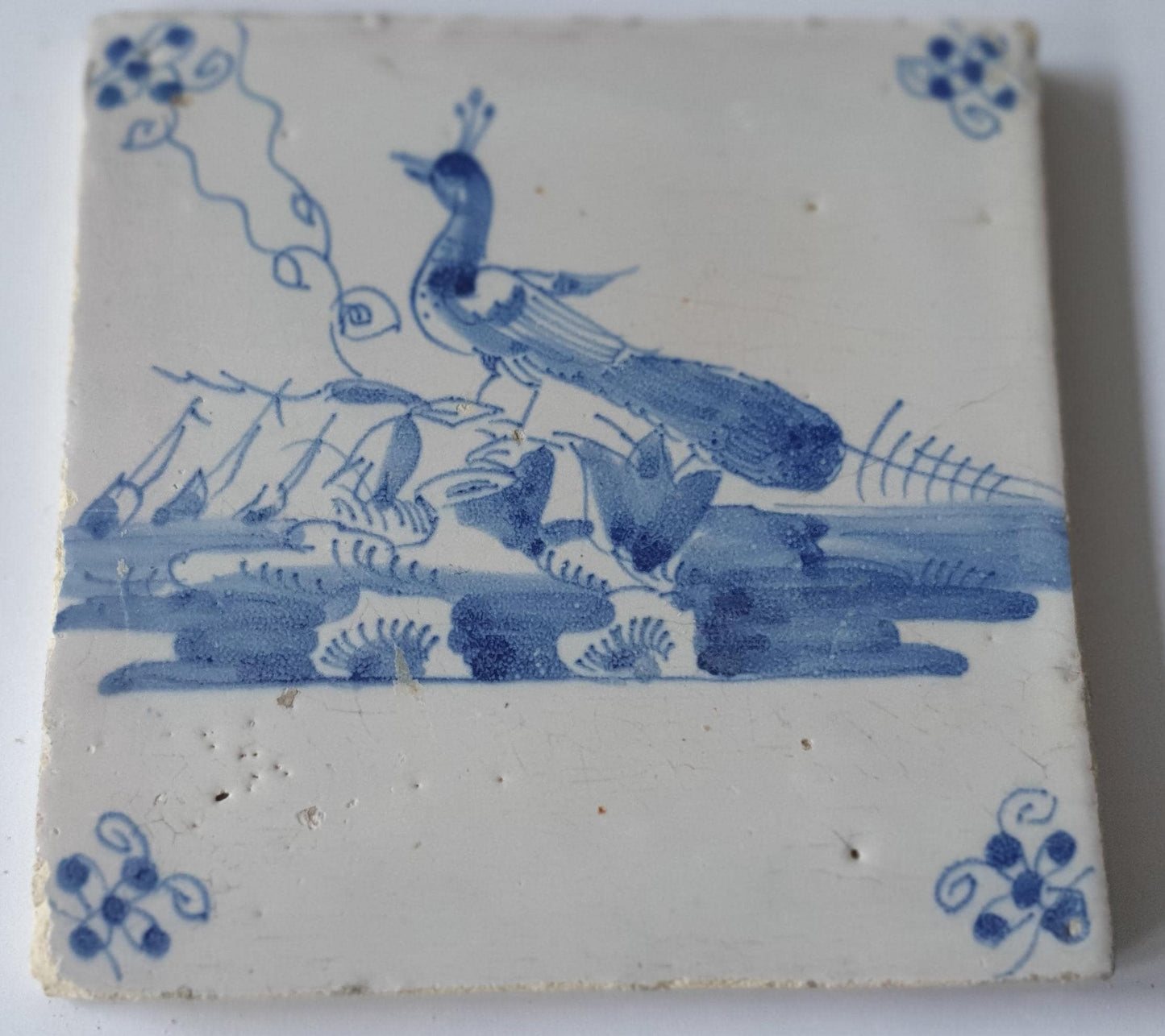 This  Delft tile depicts a peacock in blue.