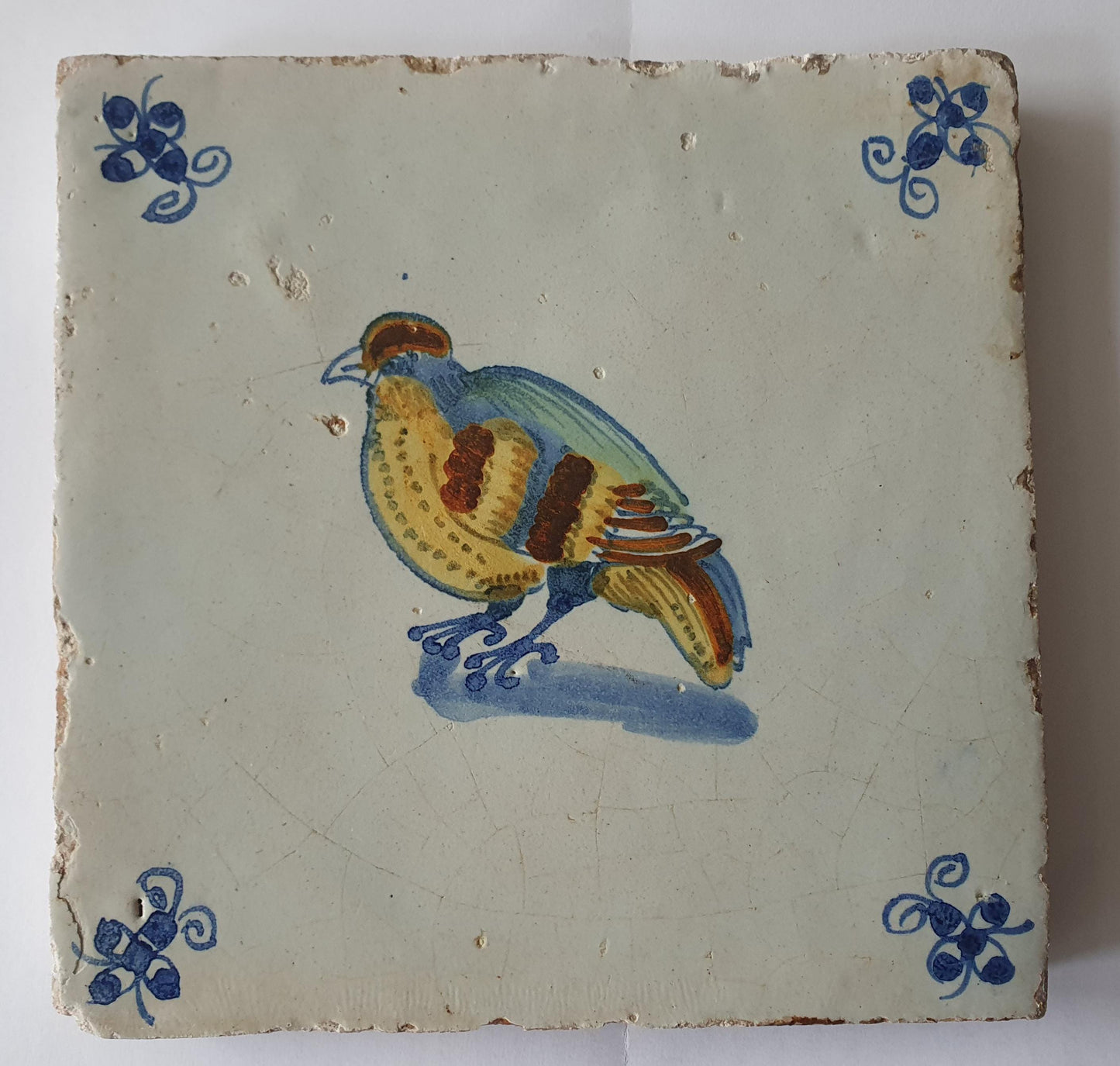 This antique Delft tile dates from around 1640 and depicts a beautifully hand-painted polychrome bird .