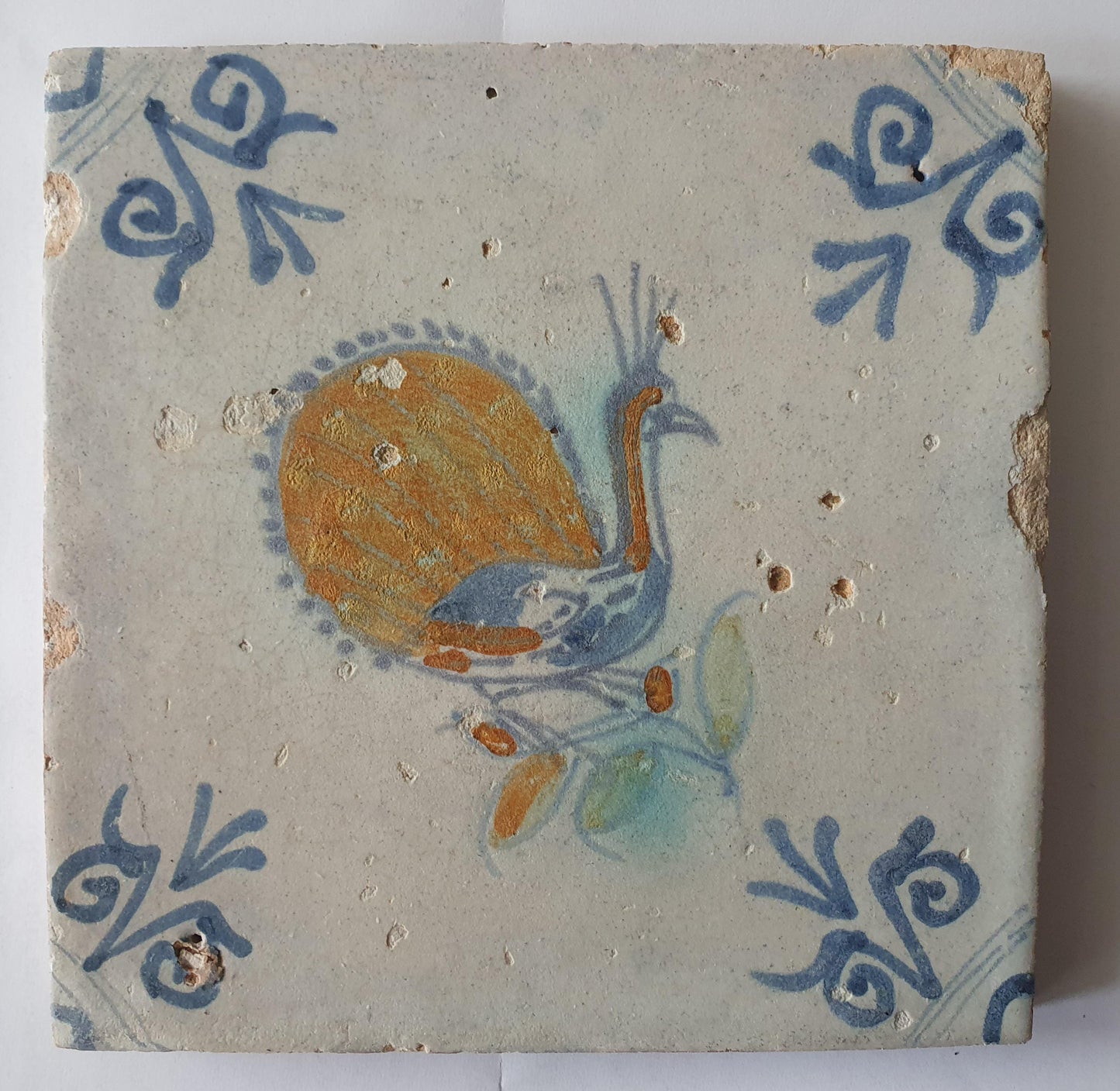 This 17th-century antique tile depicts a vividly hand-painted peacock
