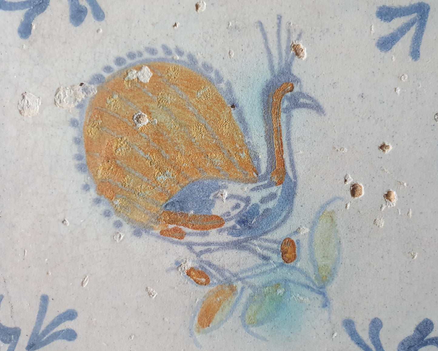 This 17th-century antique tile depicts a vividly hand-painted peacock