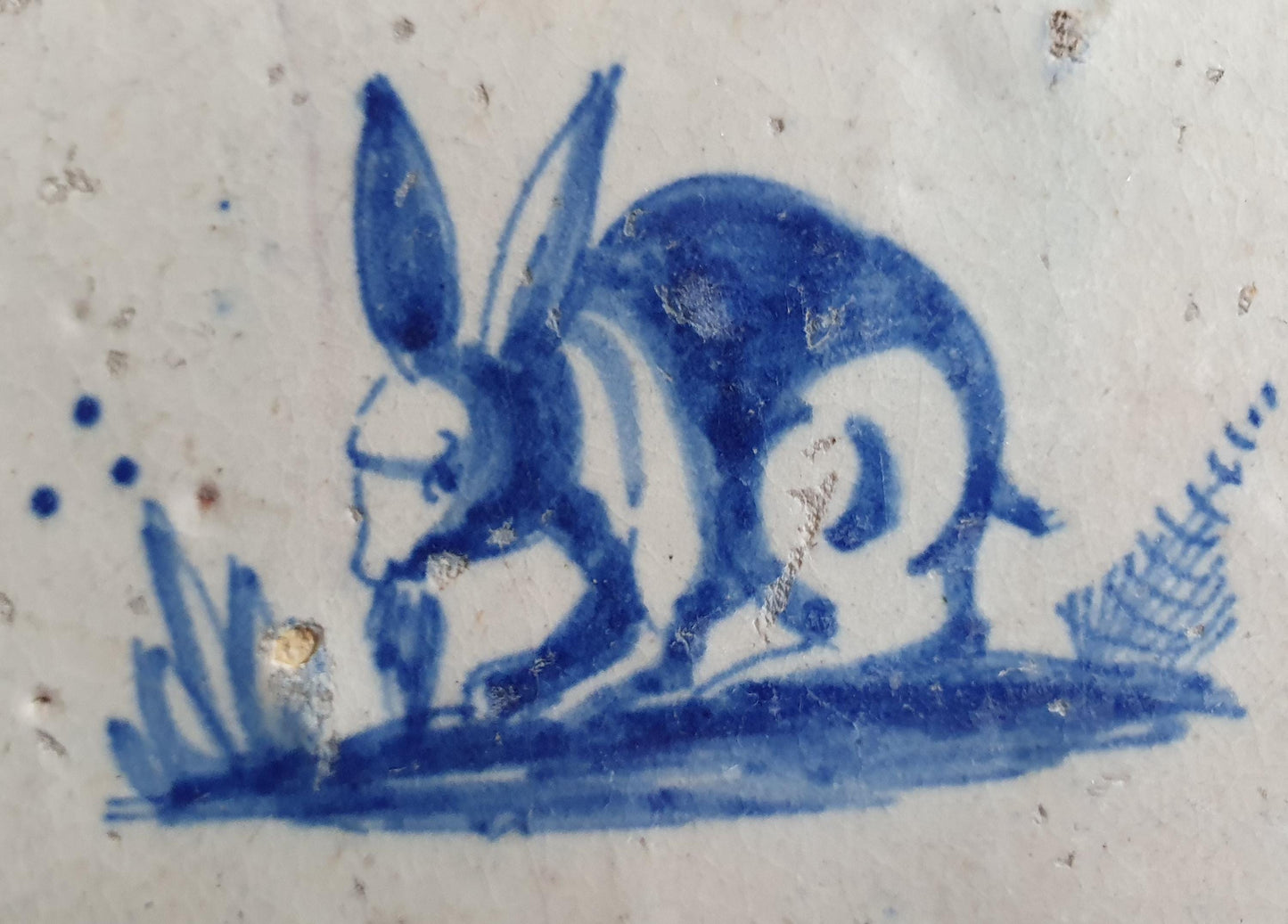 This 17th century Delft tile depicts a jumping hare , delicately painted in blue