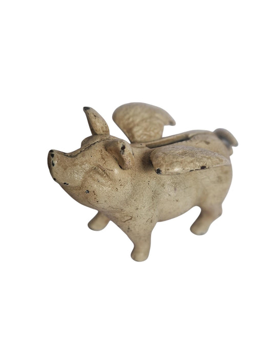 Vintage cast iron flying pig coin bank.