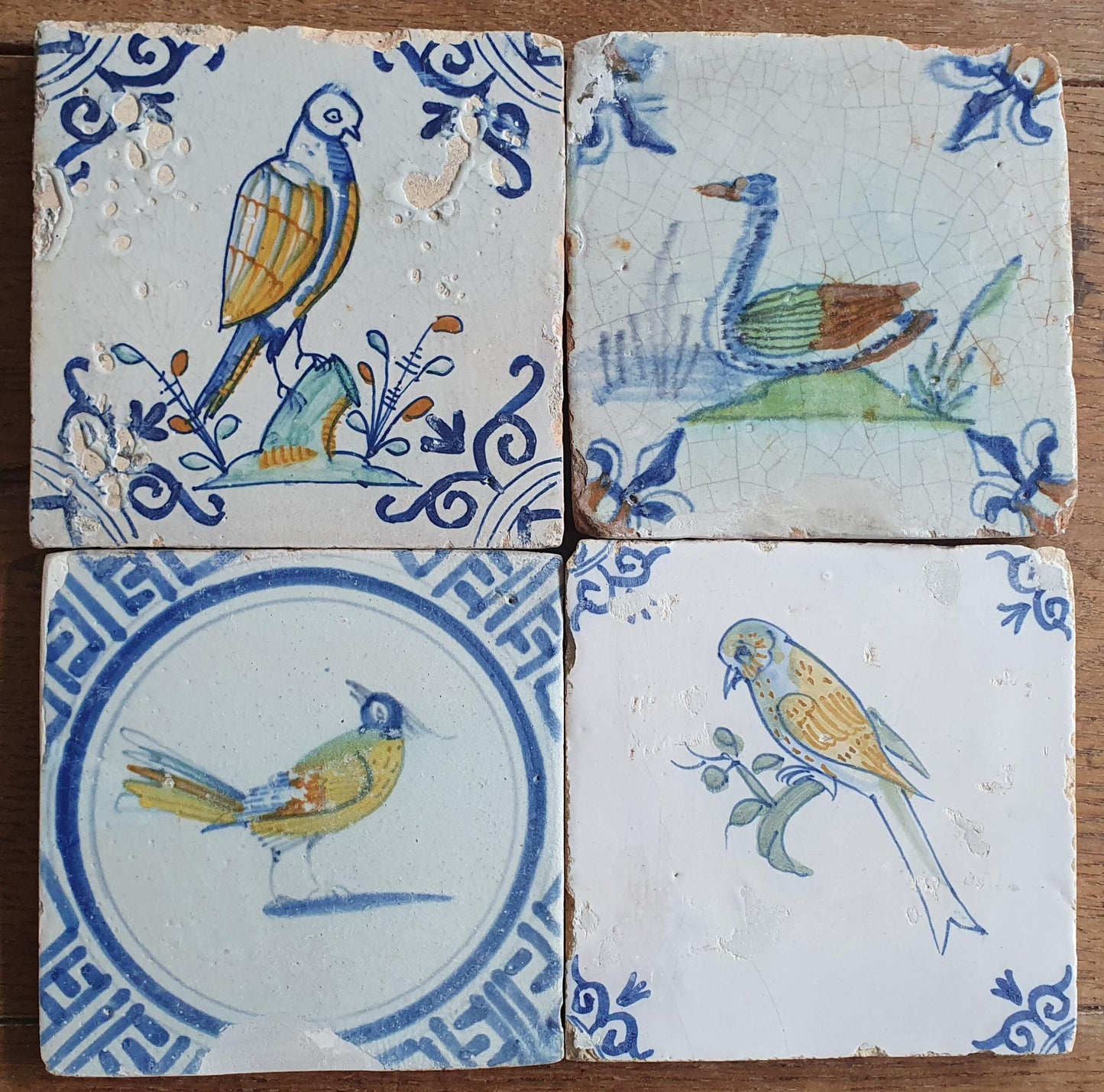 4 x Antique Delft tiles with colorful  birds. The tiles are decorated  (animaltile).