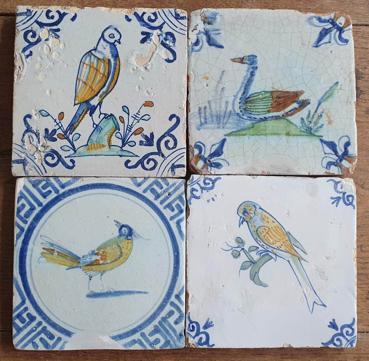 4 x Antique Delft tiles with colorful  birds. The tiles are decorated  (animaltile).