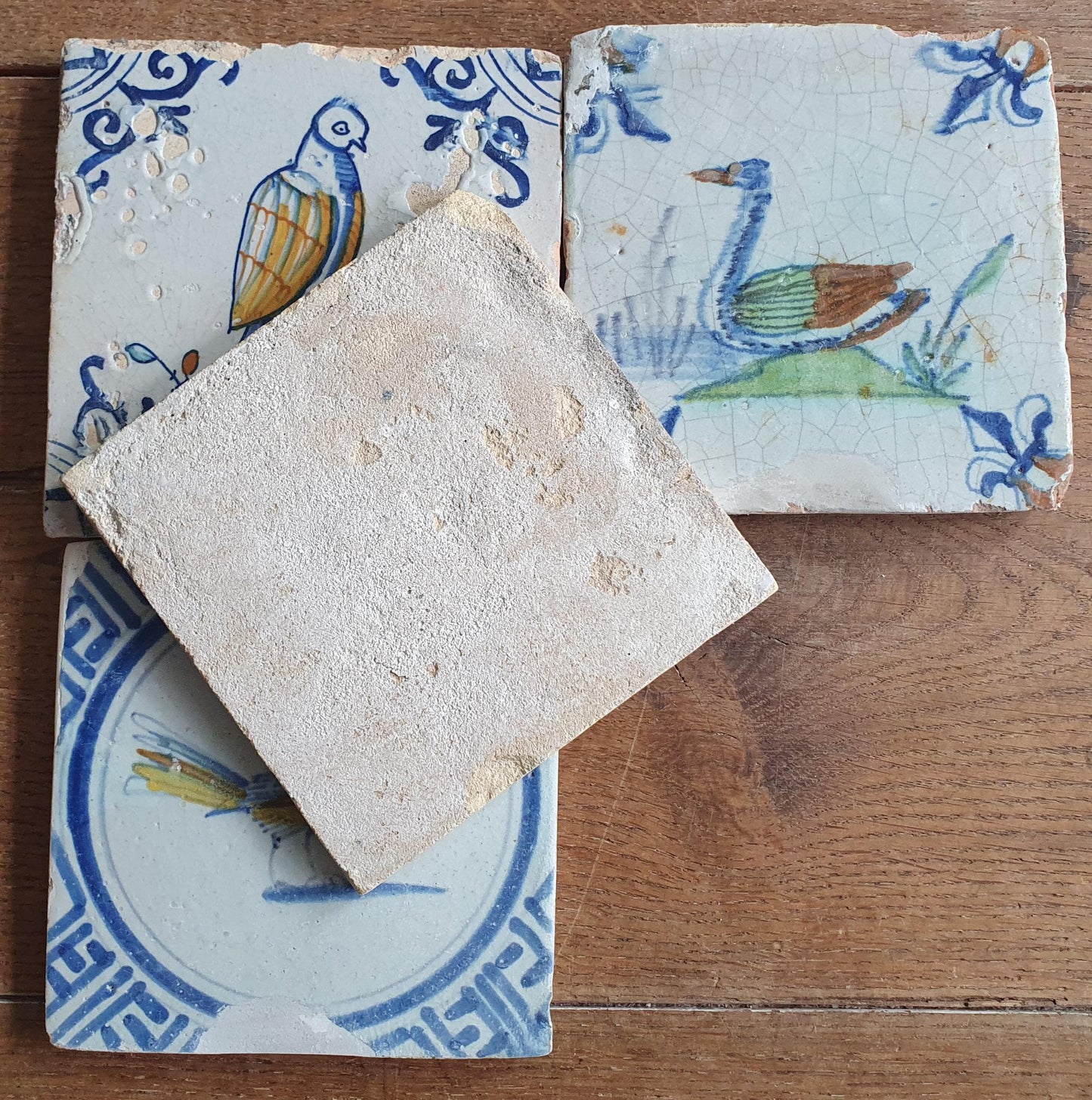 4 x Antique Delft tiles with colorful  birds. The tiles are decorated  (animaltile).