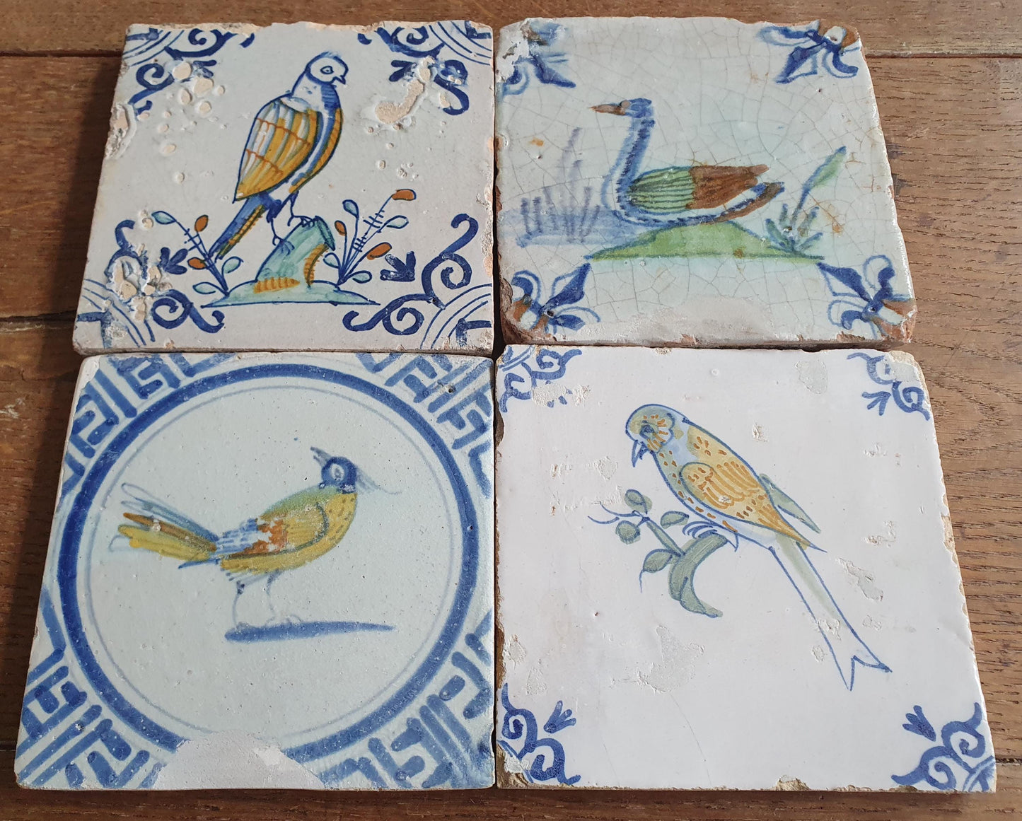 4 x Antique Delft tiles with colorful  birds. The tiles are decorated  (animaltile).