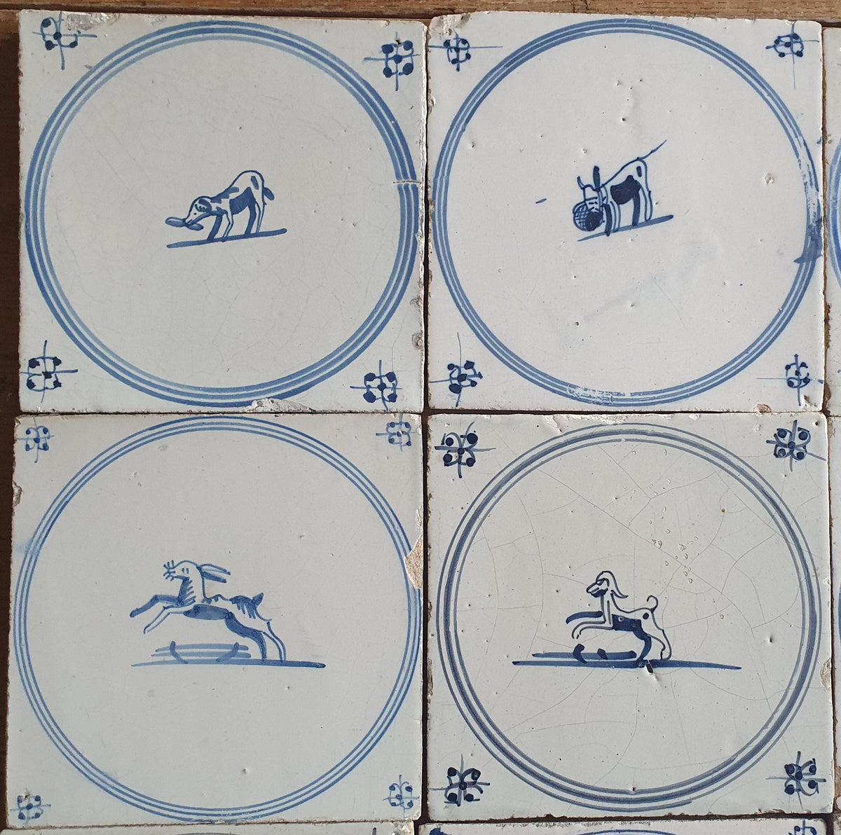 A set of 12 antique 18th-century Delft tiles. Dutch Delft Blue, circular tiles with animaltiles