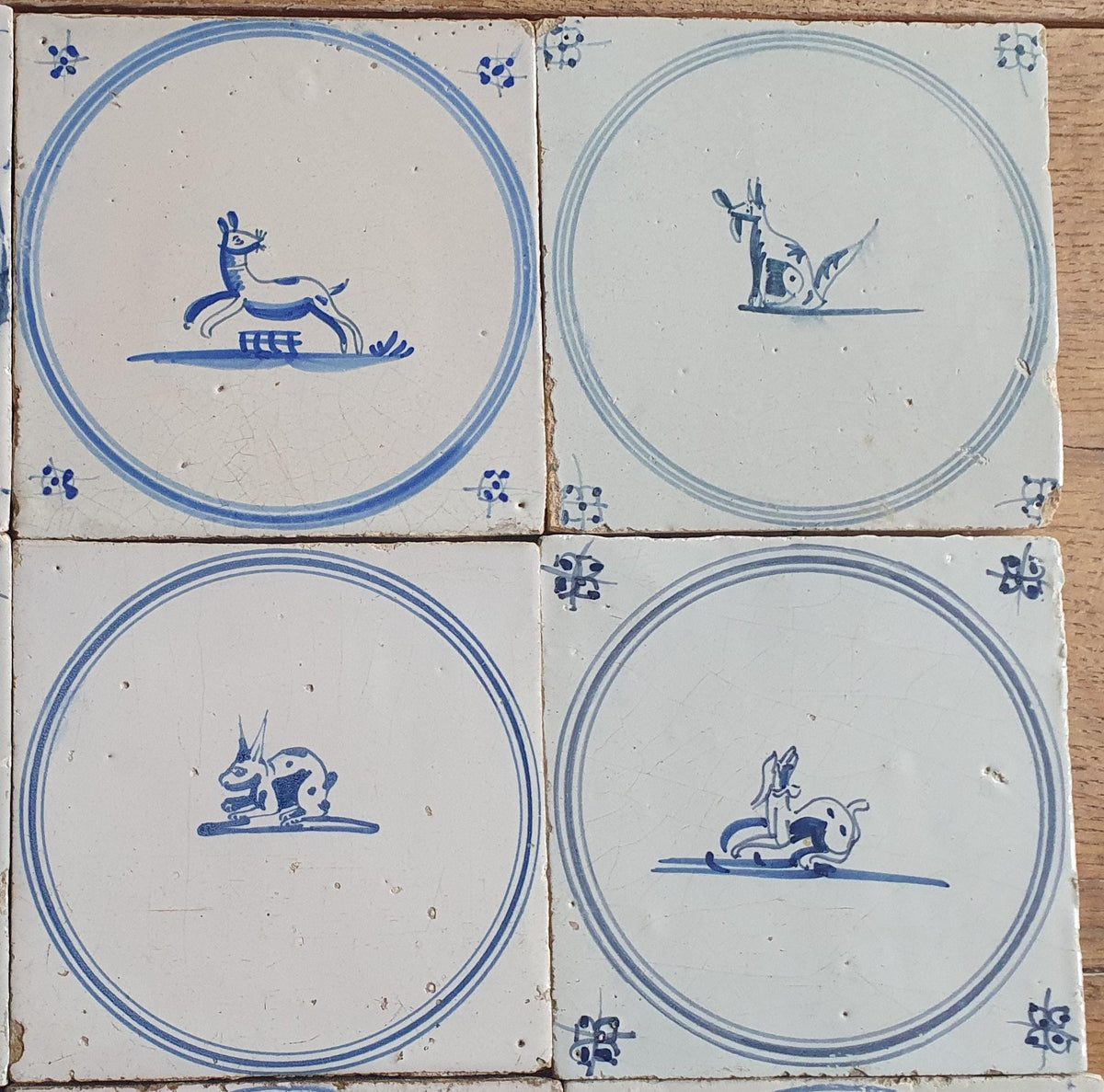 A set of 12 antique 18th-century Delft tiles. Dutch Delft Blue, circular tiles with animaltiles