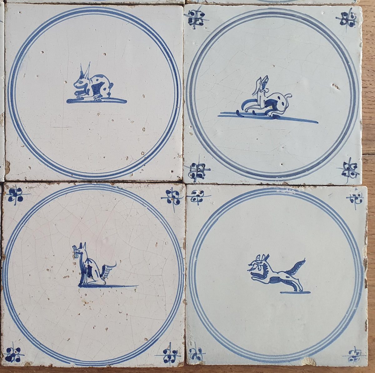 A set of 12 antique 18th-century Delft tiles. Dutch Delft Blue, circular tiles with animaltiles