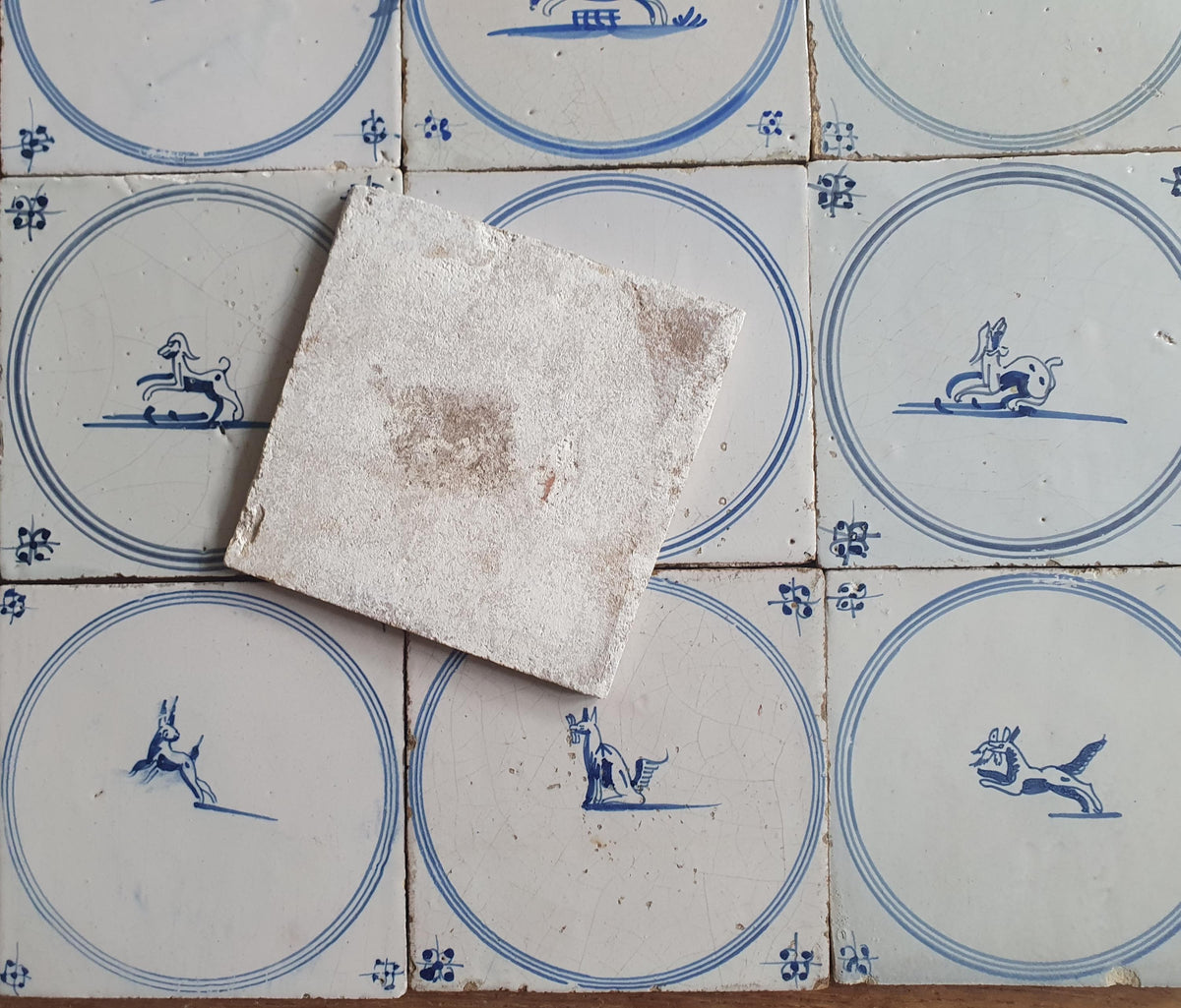 A set of 12 antique 18th-century Delft tiles. Dutch Delft Blue, circular tiles with animaltiles