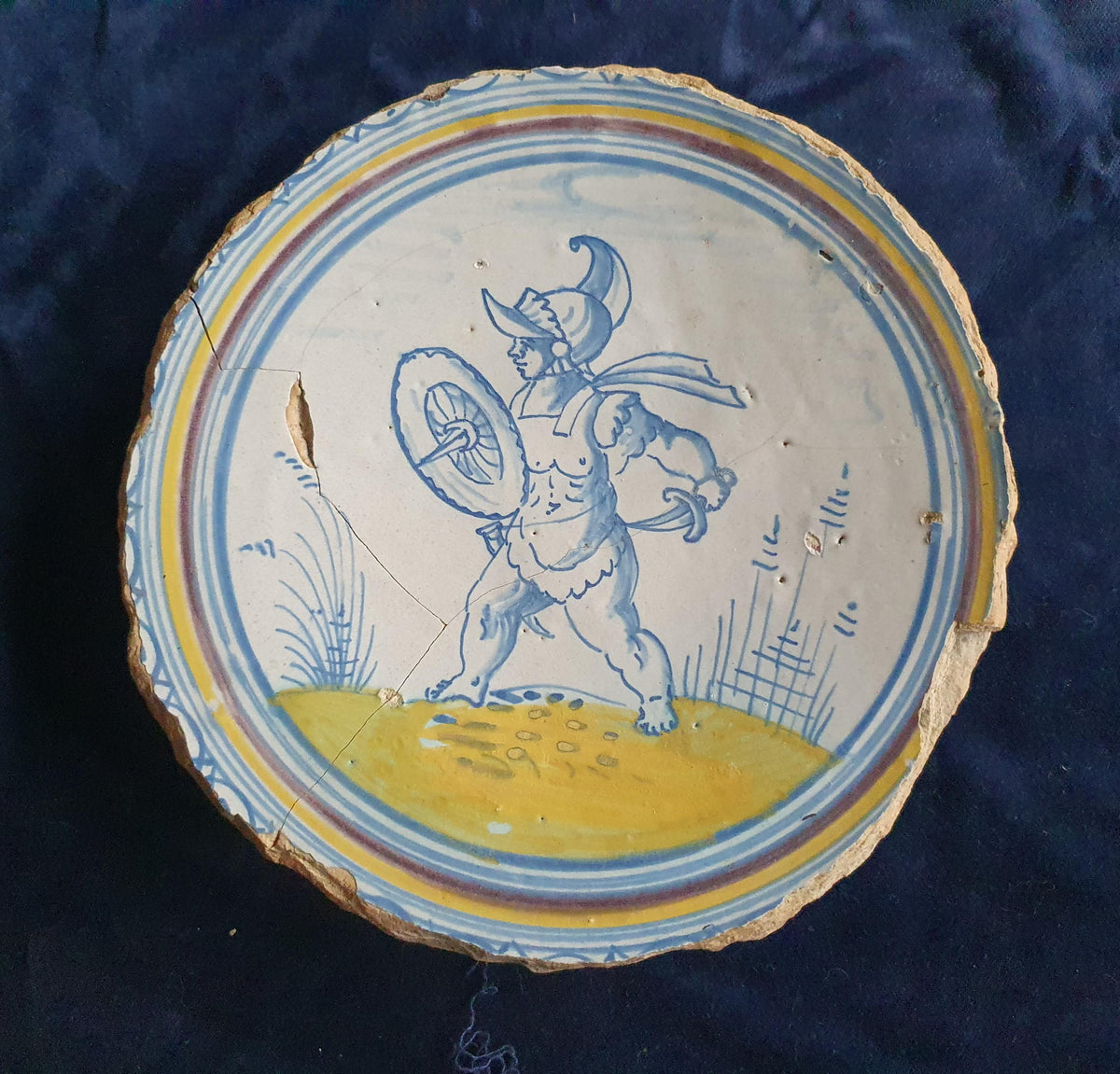 A rare, large plate fragment featuring, in the central area, an image of a striding Roman warrior. 17th