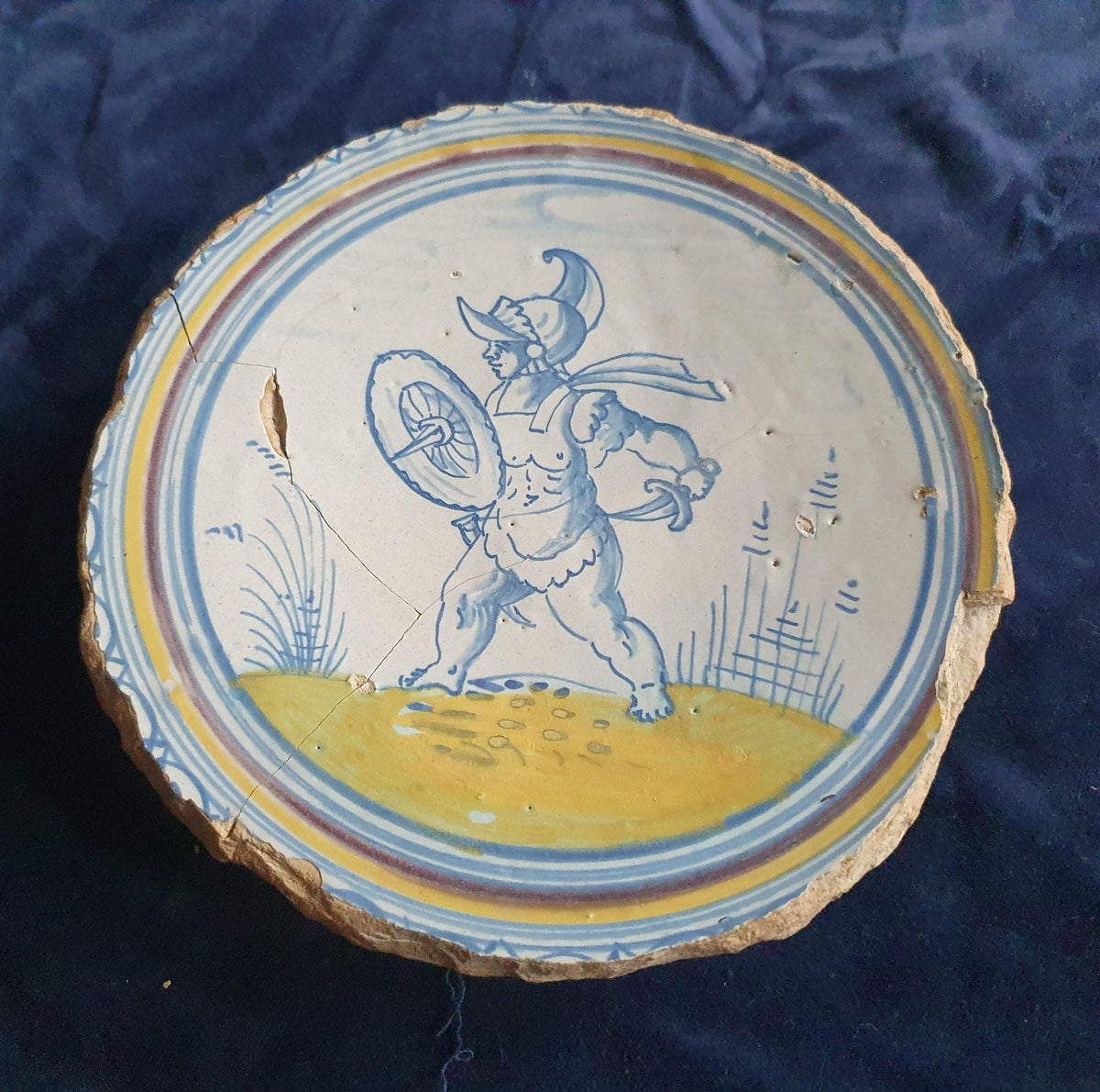 A rare, large plate fragment featuring, in the central area, an image of a striding Roman warrior. 17th