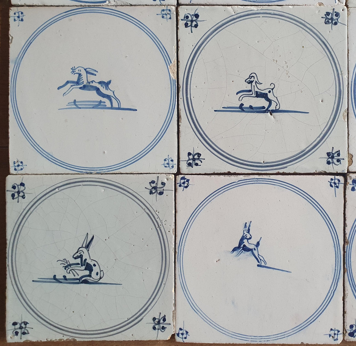 A set of 12 antique 18th-century Delft tiles. Dutch Delft Blue, circular tiles with animaltiles