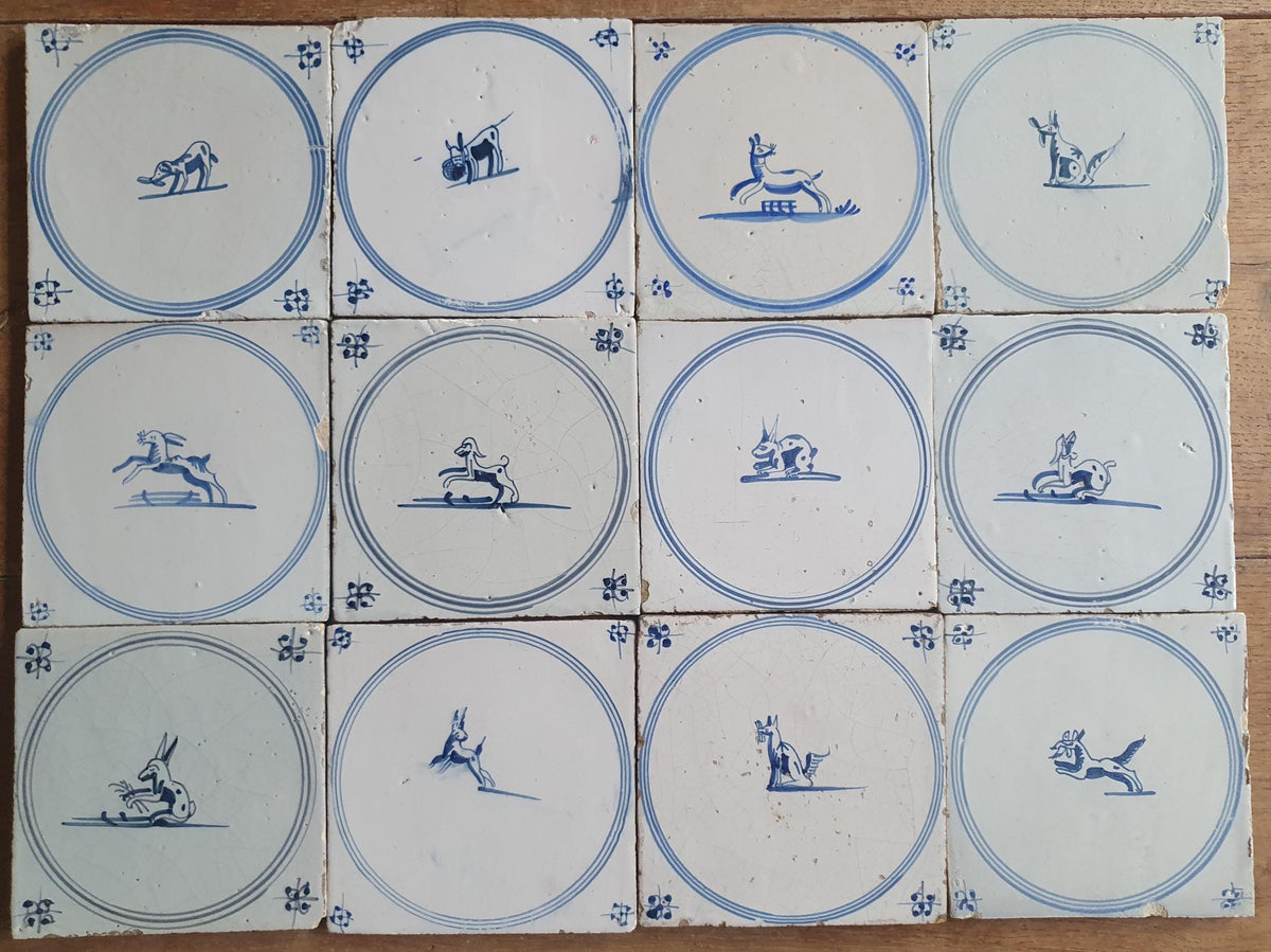 A set of 12 antique 18th-century Delft tiles. Dutch Delft Blue, circular tiles with animaltiles