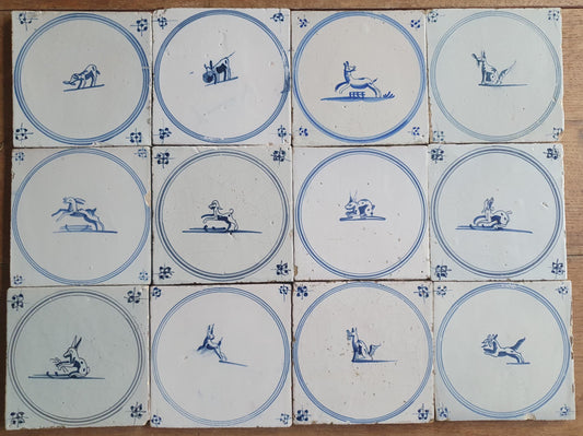 A set of 12 antique 18th-century Delft tiles. Dutch Delft Blue, circular tiles with animaltiles
