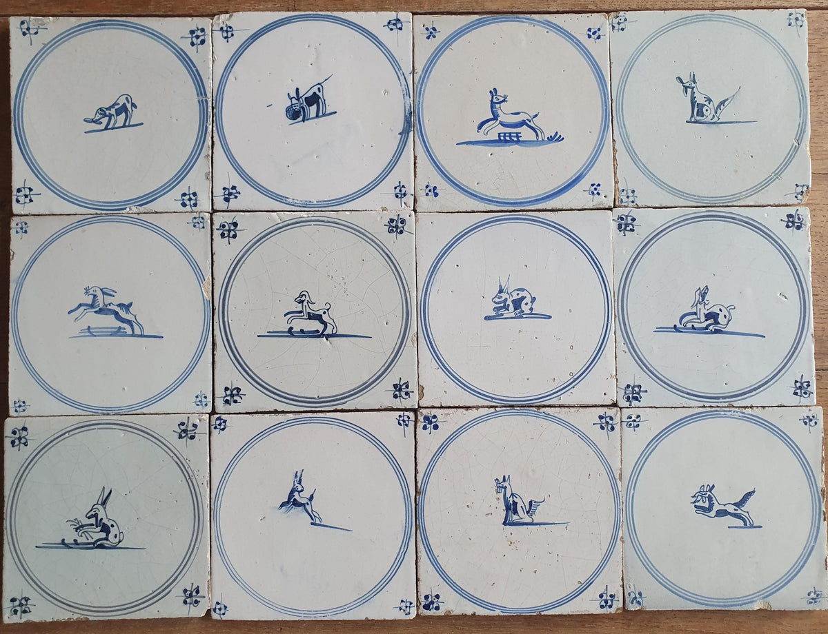 A set of 12 antique 18th-century Delft tiles. Dutch Delft Blue, circular tiles with animaltiles