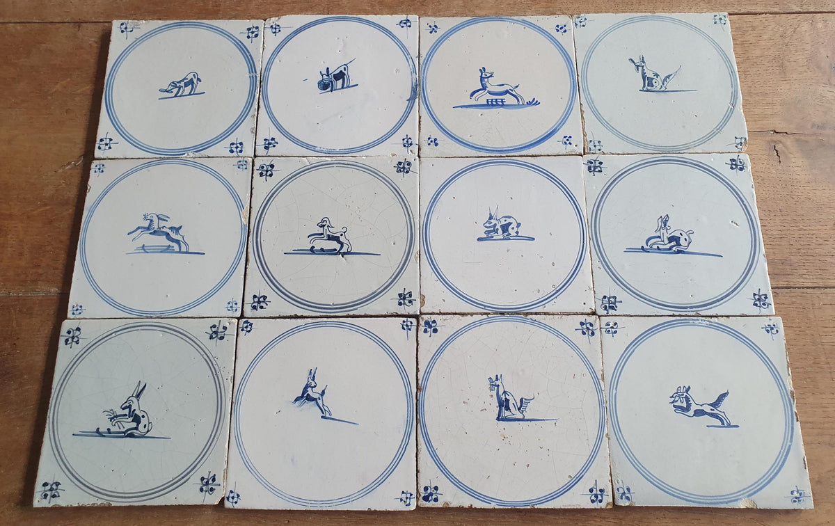 A set of 12 antique 18th-century Delft tiles. Dutch Delft Blue, circular tiles with animaltiles