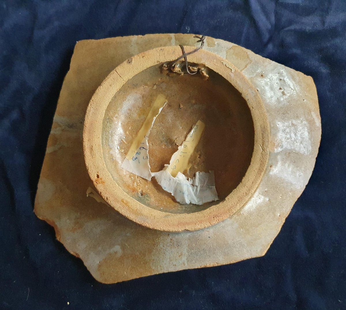 A rare, large shard from a plate, featuring a depiction on the base of a striding putto with a bow and arrow. 17th