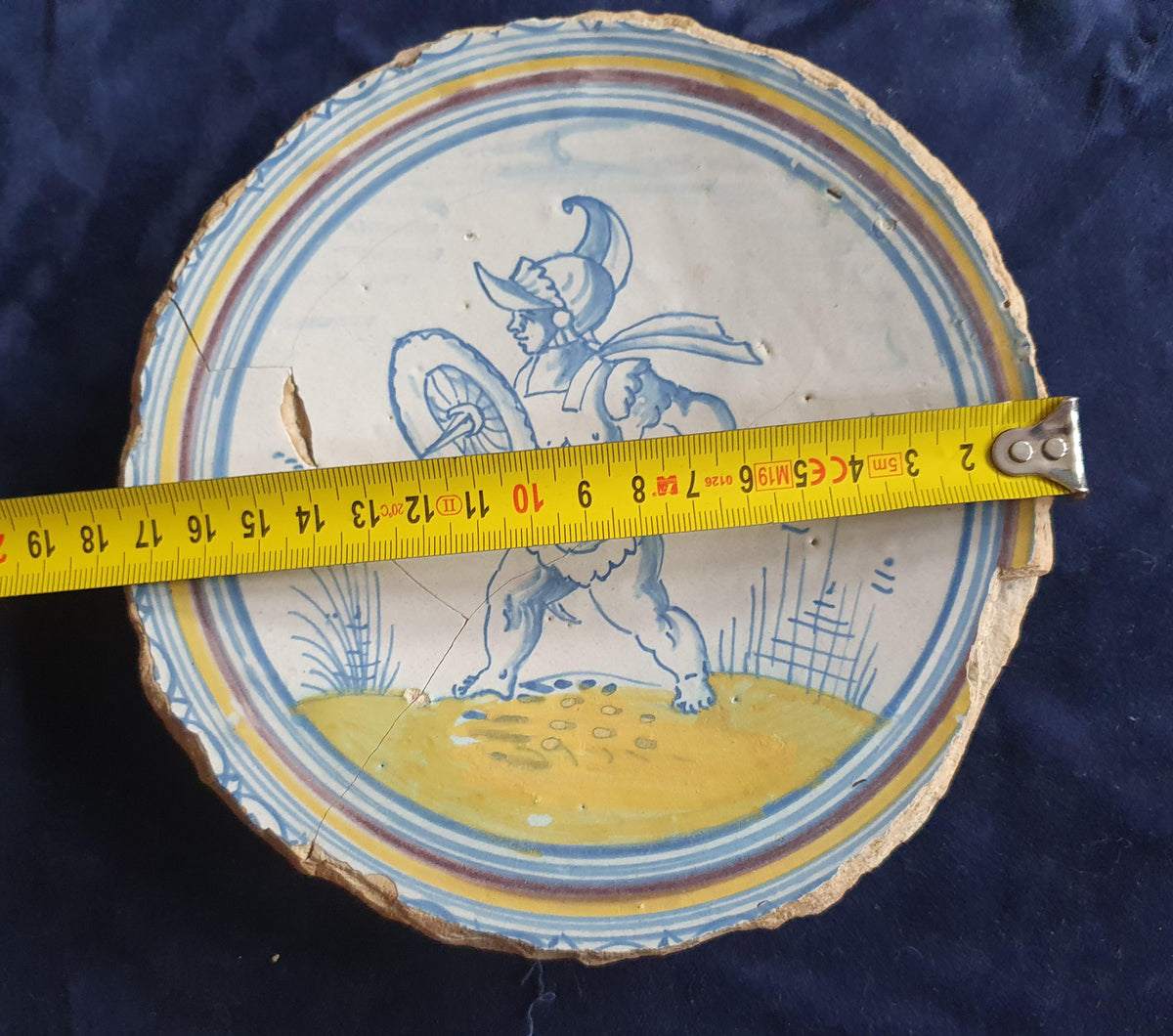 A rare, large plate fragment featuring, in the central area, an image of a striding Roman warrior. 17th