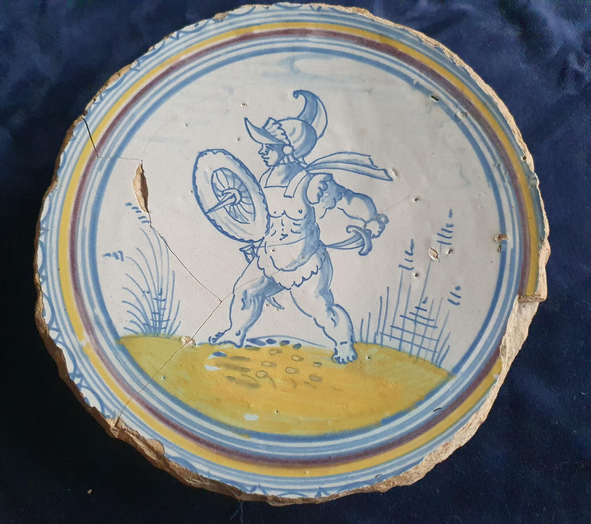 A rare, large plate fragment featuring, in the central area, an image of a striding Roman warrior. 17th