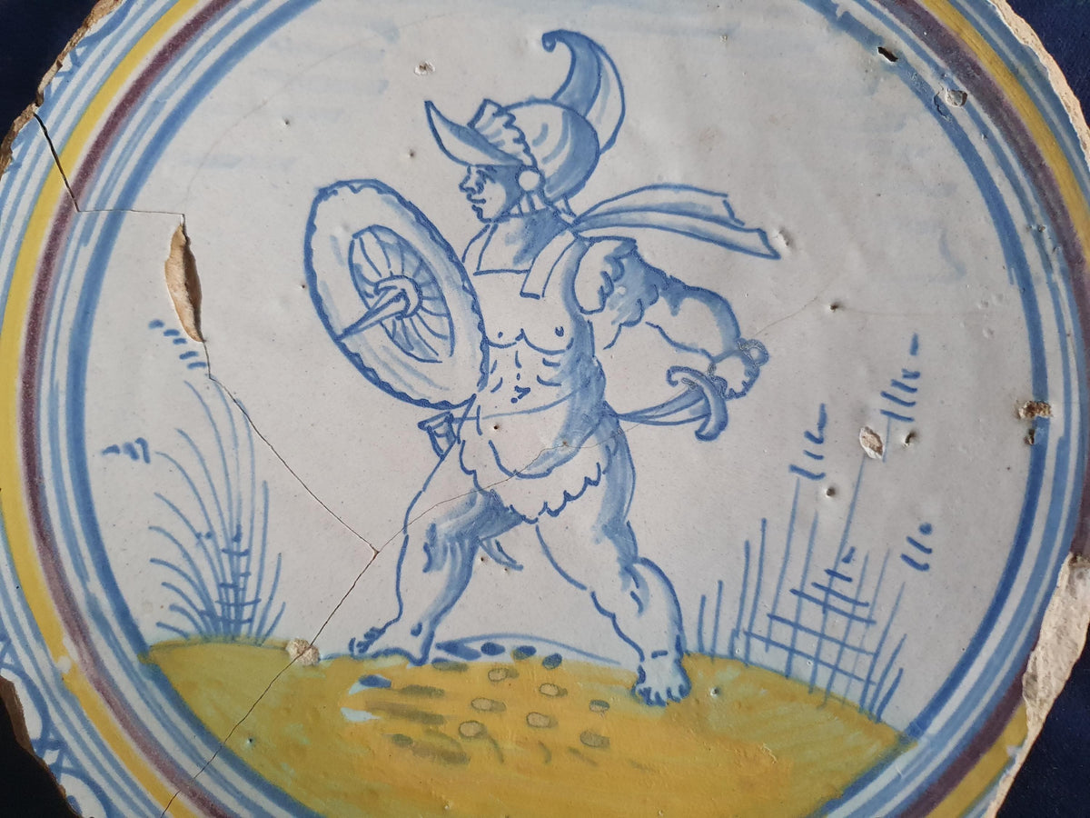 A rare, large plate fragment featuring, in the central area, an image of a striding Roman warrior. 17th