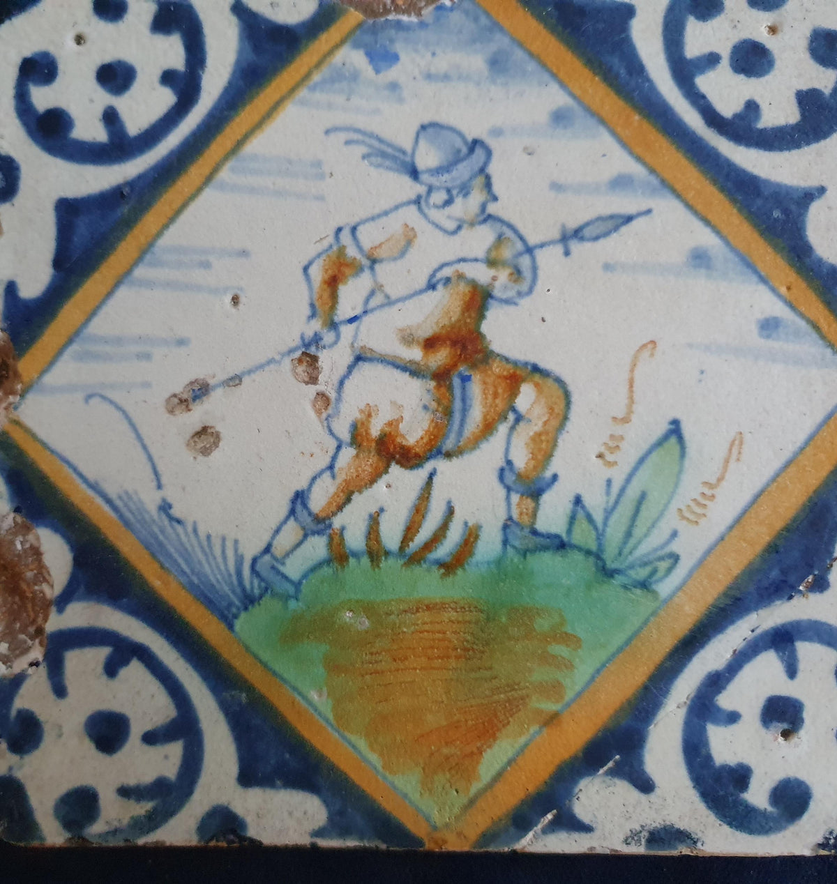 Early 17th-century (c. 1620) Delft square tile, polychrome-painted and depicting a soldier with a spear. Figuretile