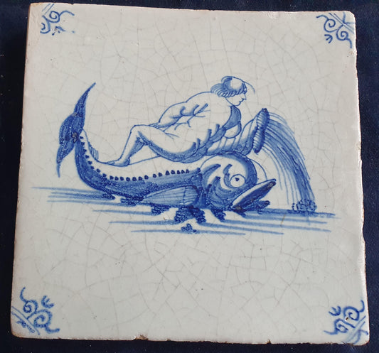 Delft tile depicts putti on top of dolphin. around 1660 mythicaltile