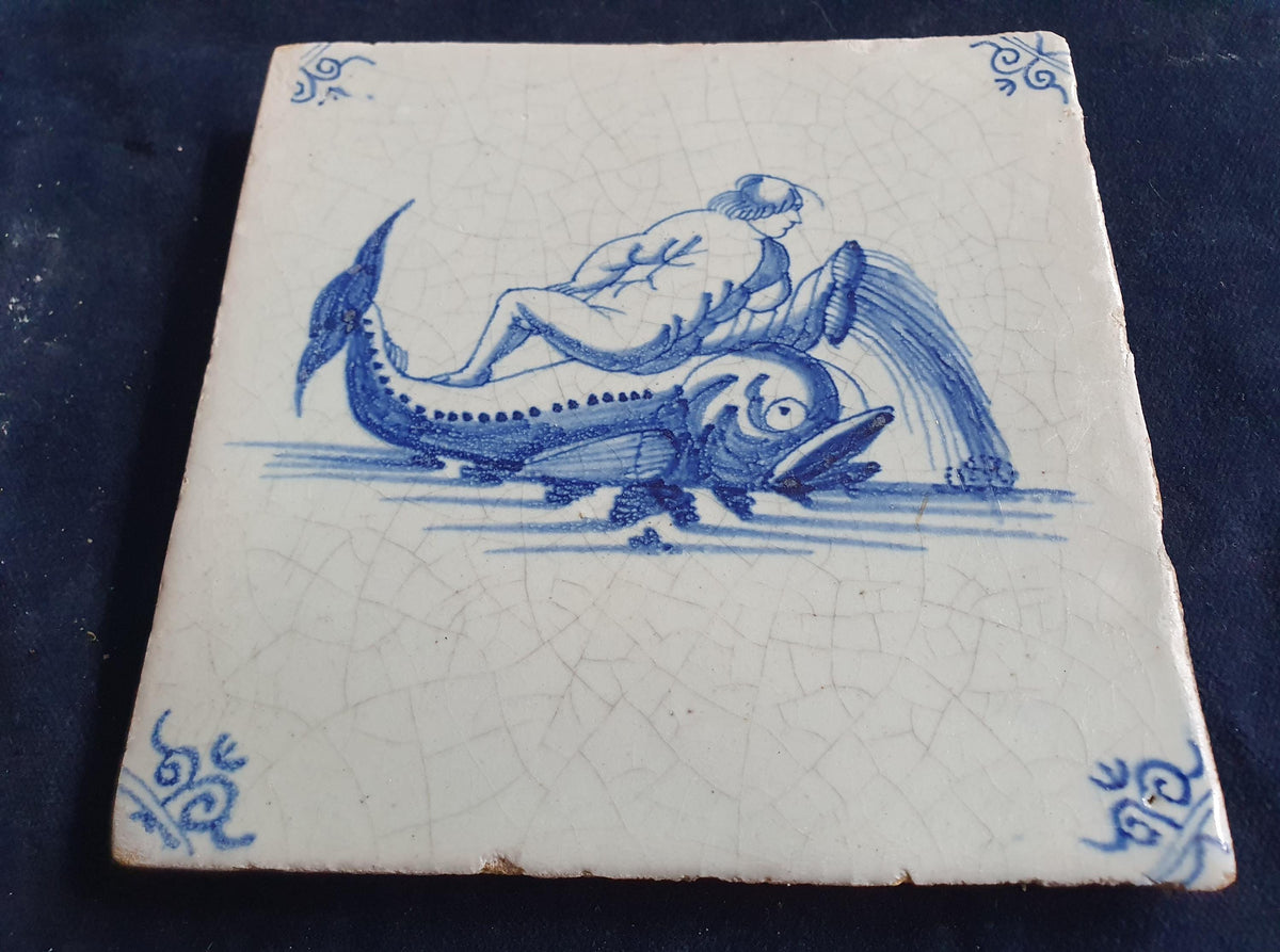 Delft tile depicts putti on top of dolphin. around 1660 mythicaltile