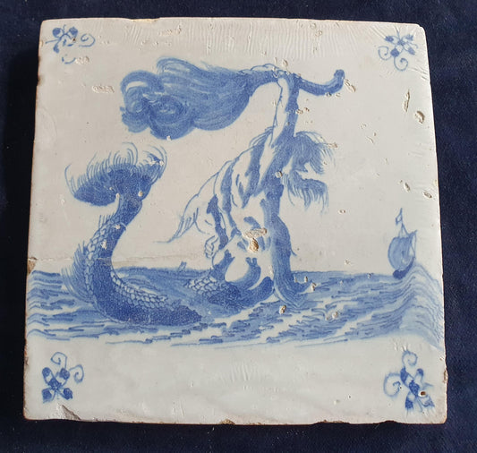 This antique Delft seacreature tile depicts a fierce-looking merman. around 1660 mythicaltile