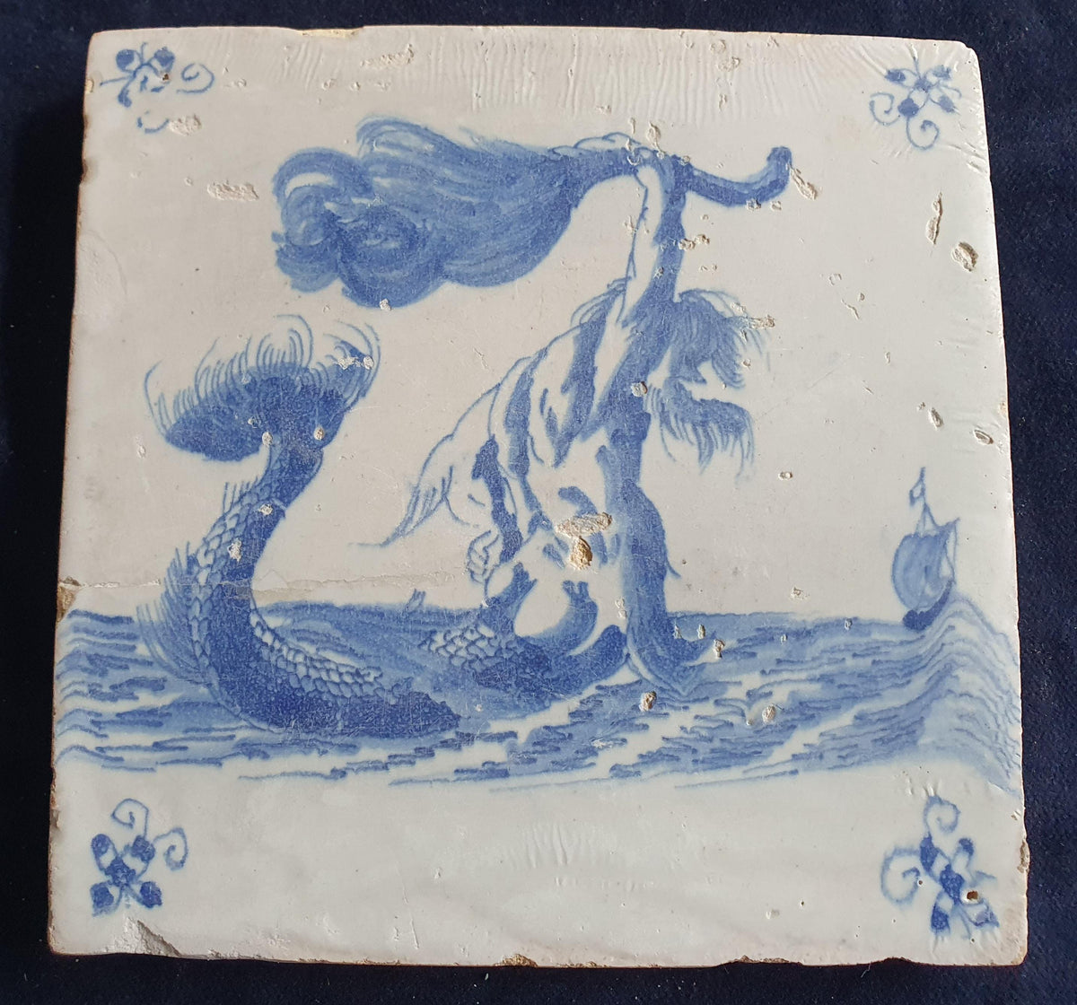 This antique Delft seacreature tile depicts a fierce-looking merman. around 1660 mythicaltile
