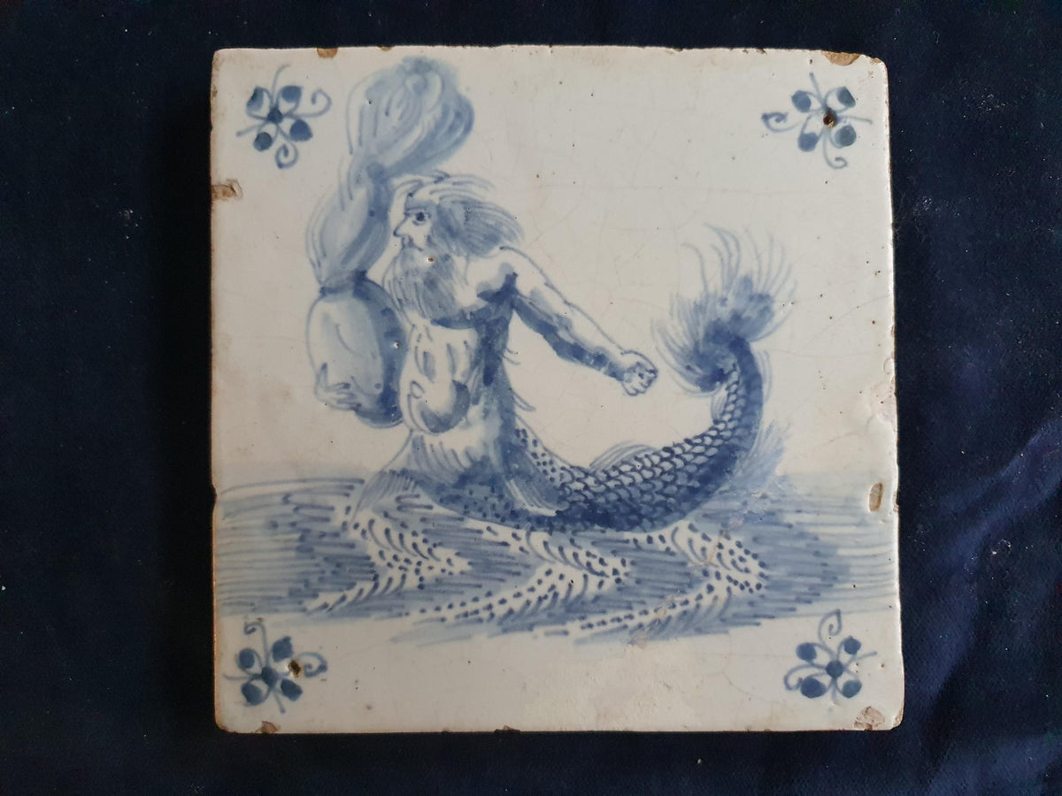 Antique Delft tile depicts a fierce-looking sailor holding a burning po. around 1660 mythicaltile
