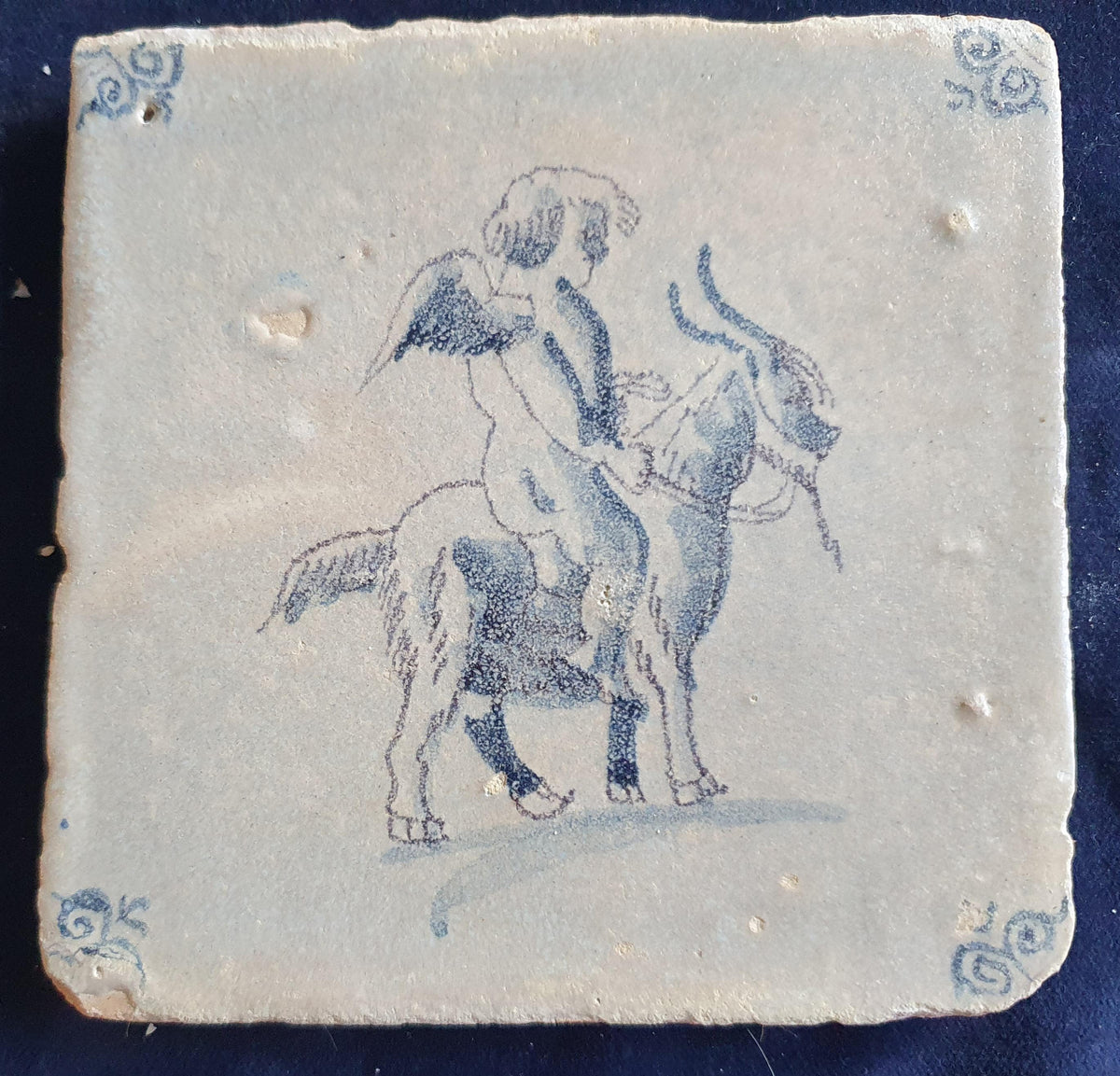 Antique magnificent tile, depicting Cupid riding a goat, is one of the rarest Delft tiles featuring Cupid. around 1660 faithtile