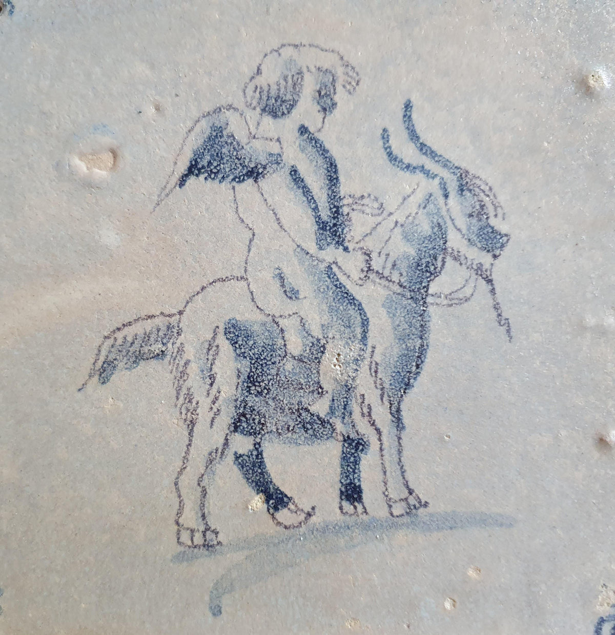 Antique magnificent tile, depicting Cupid riding a goat, is one of the rarest Delft tiles featuring Cupid. around 1660 faithtile