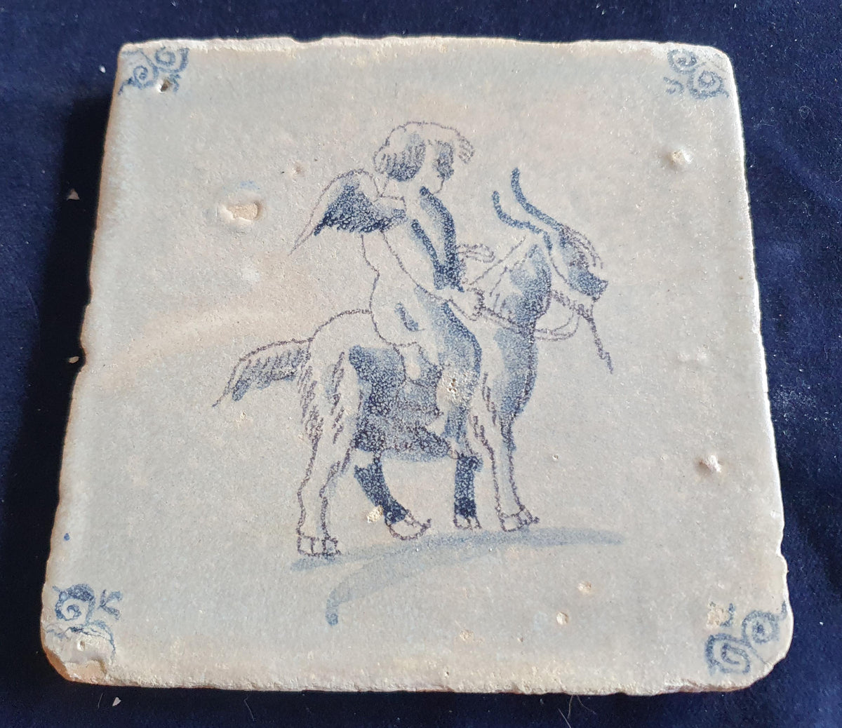 Antique magnificent tile, depicting Cupid riding a goat, is one of the rarest Delft tiles featuring Cupid. around 1660 faithtile