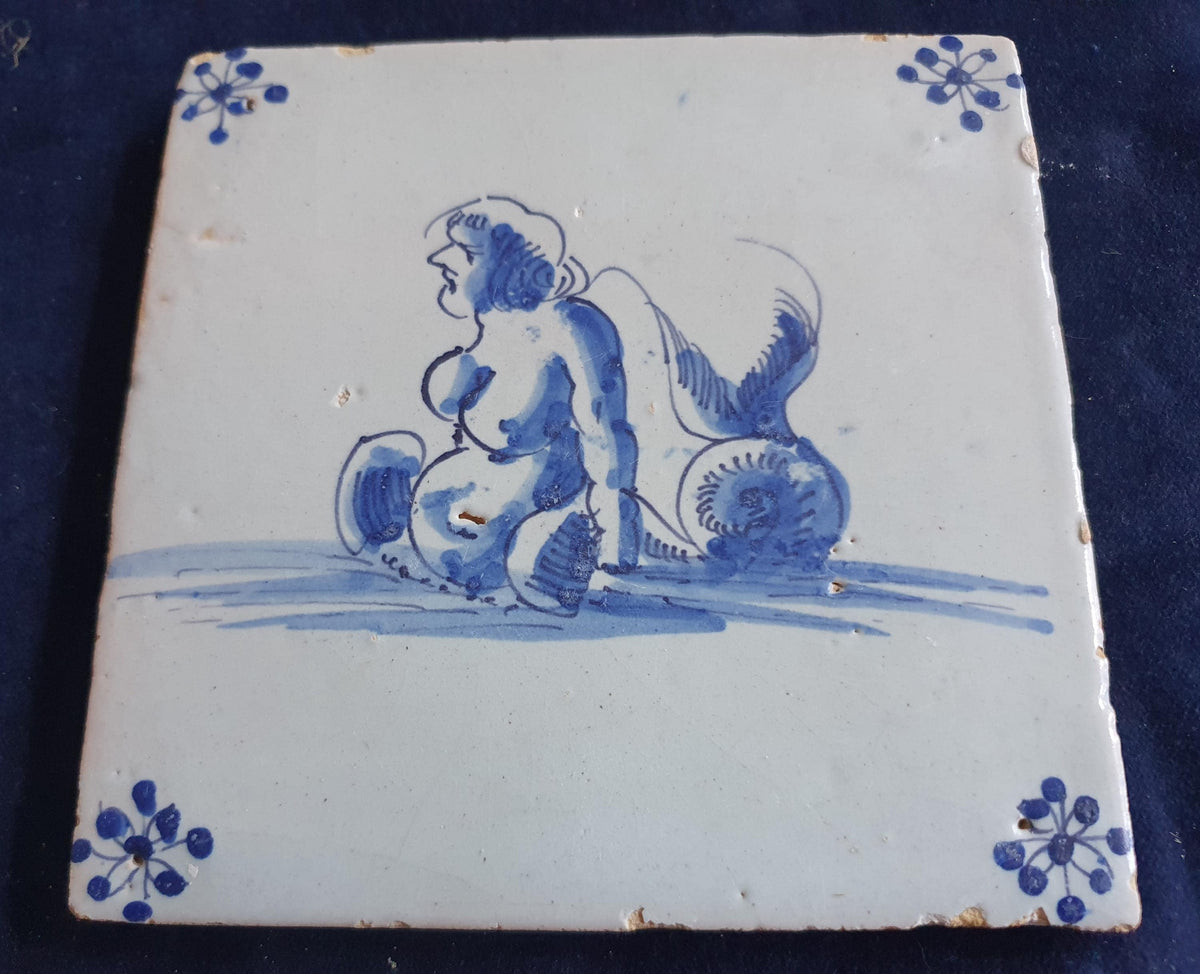 Delft tile with  a merman was produced around 1650 .  mythicaltile