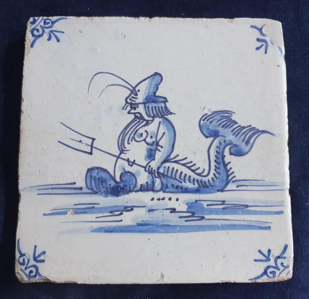Delft tile with  a merman was produced around 1660 .  mythicaltile