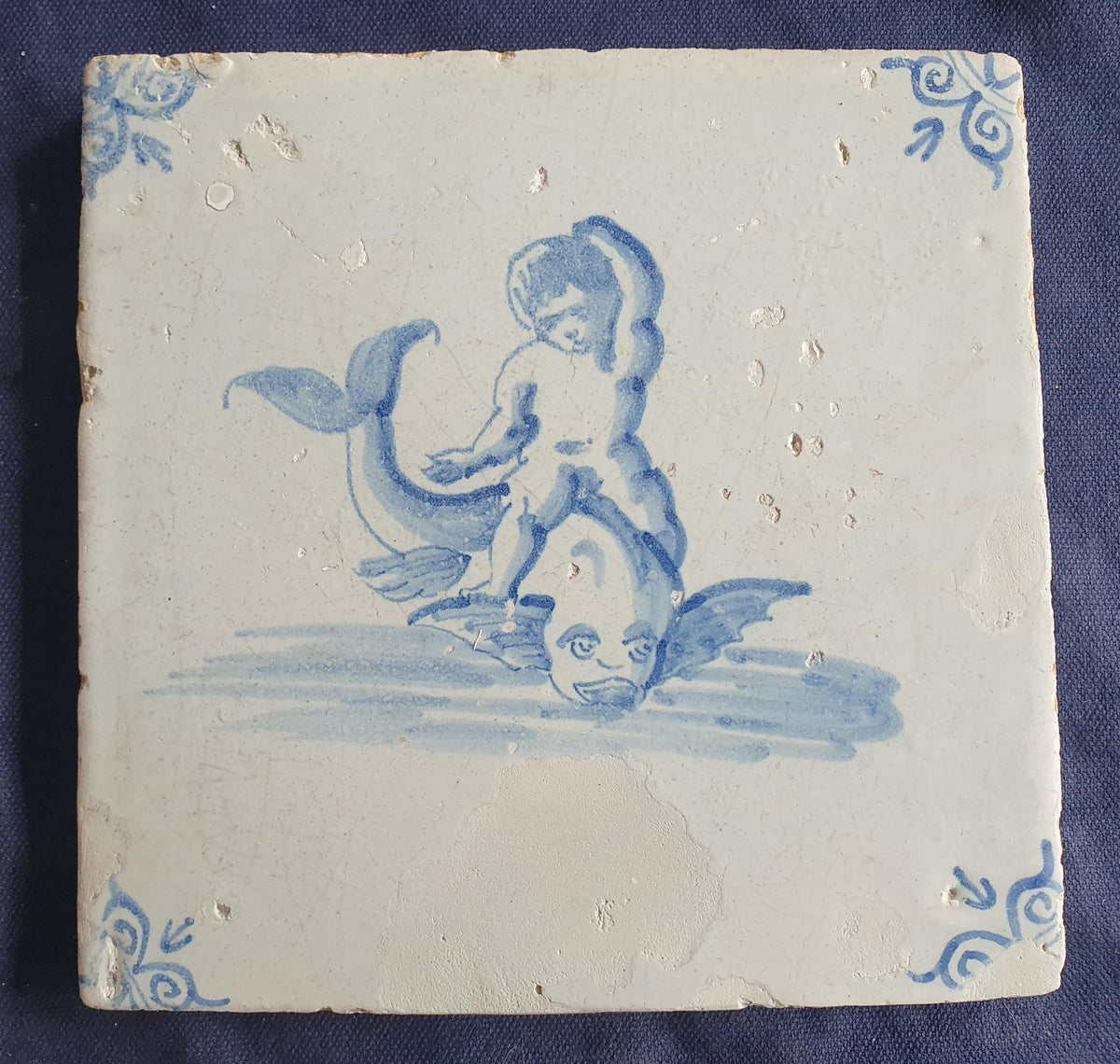 Antique magnificent tile, depicting Cupid riding a fish , is one of the rarest Delft tiles featuring Cupid. around 1640 faithtile