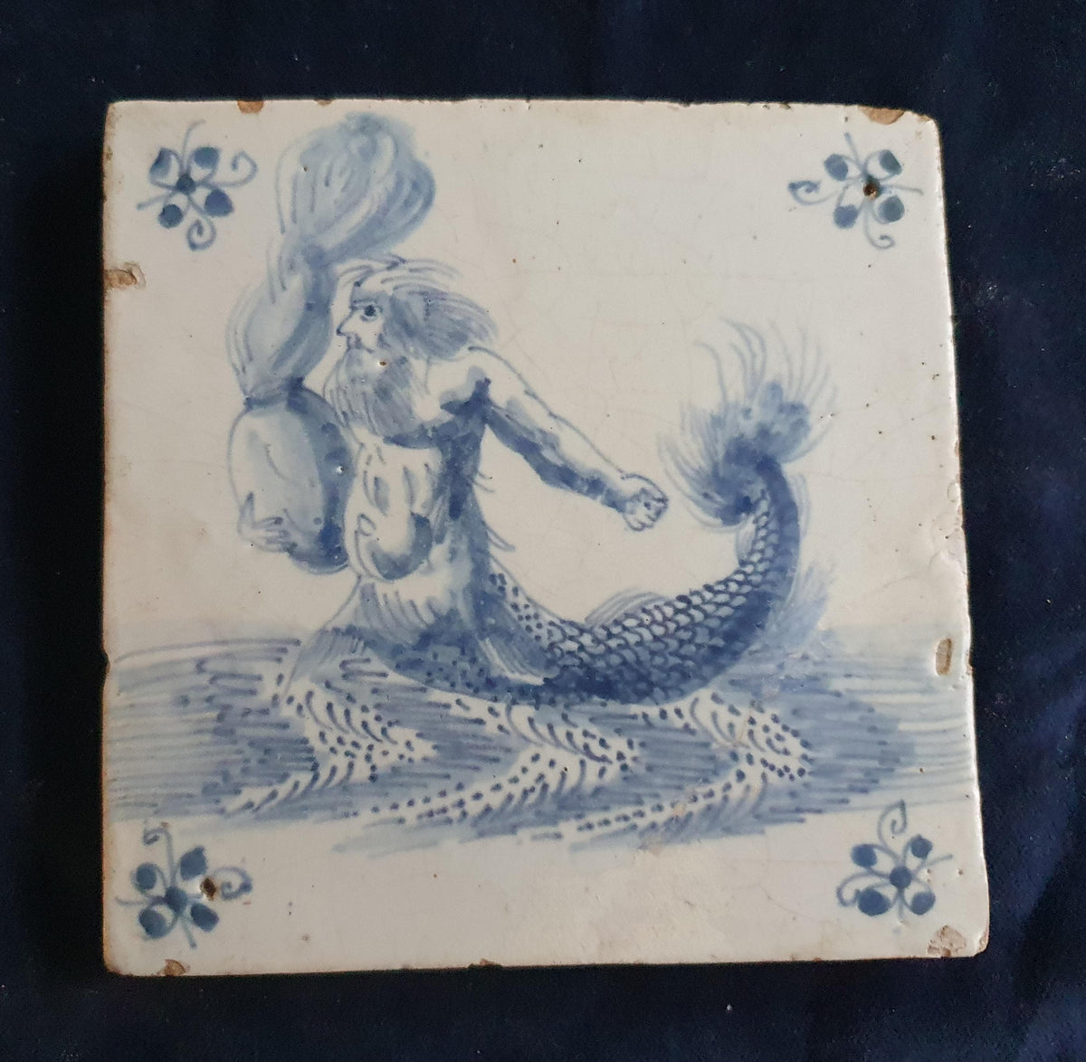 Antique Delft tile depicts a fierce-looking sailor holding a burning po. around 1660 mythicaltile