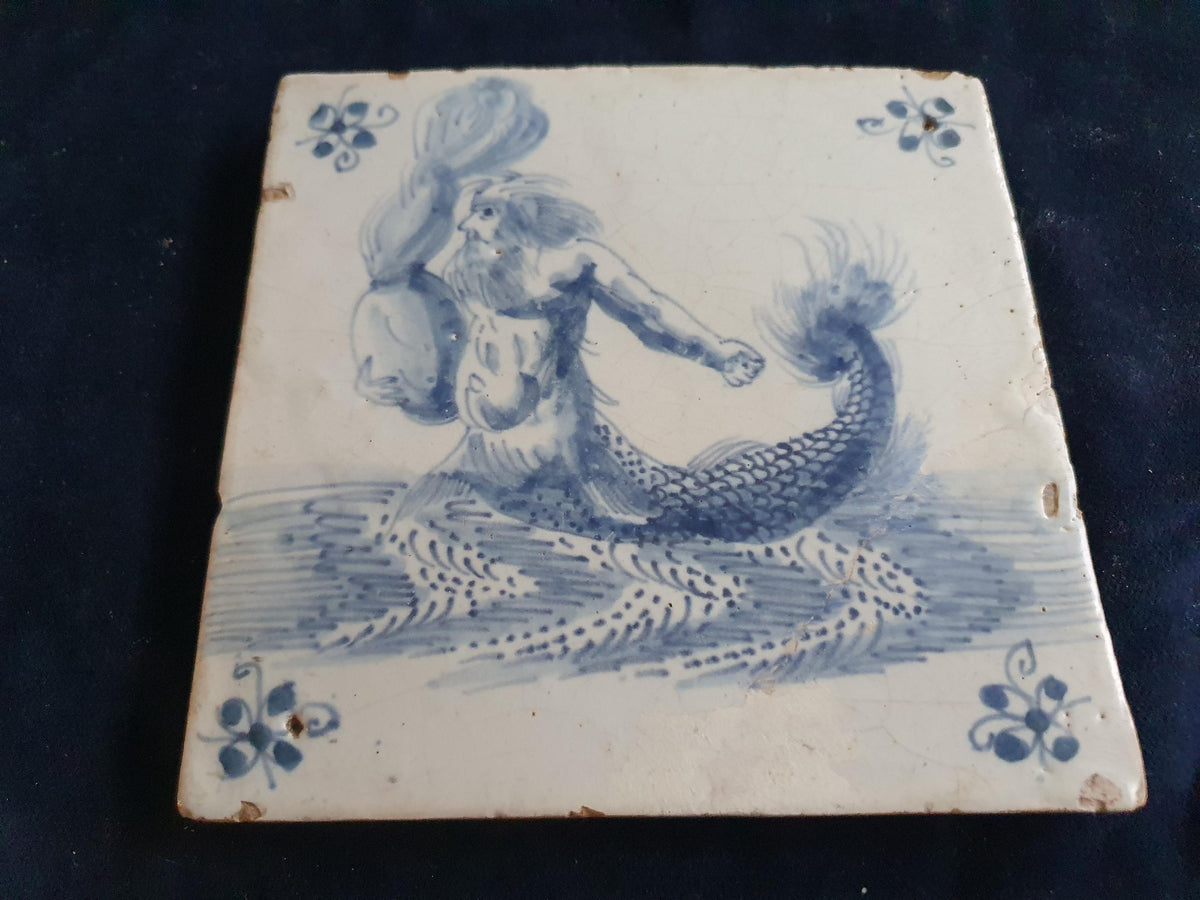 Antique Delft tile depicts a fierce-looking sailor holding a burning po. around 1660 mythicaltile